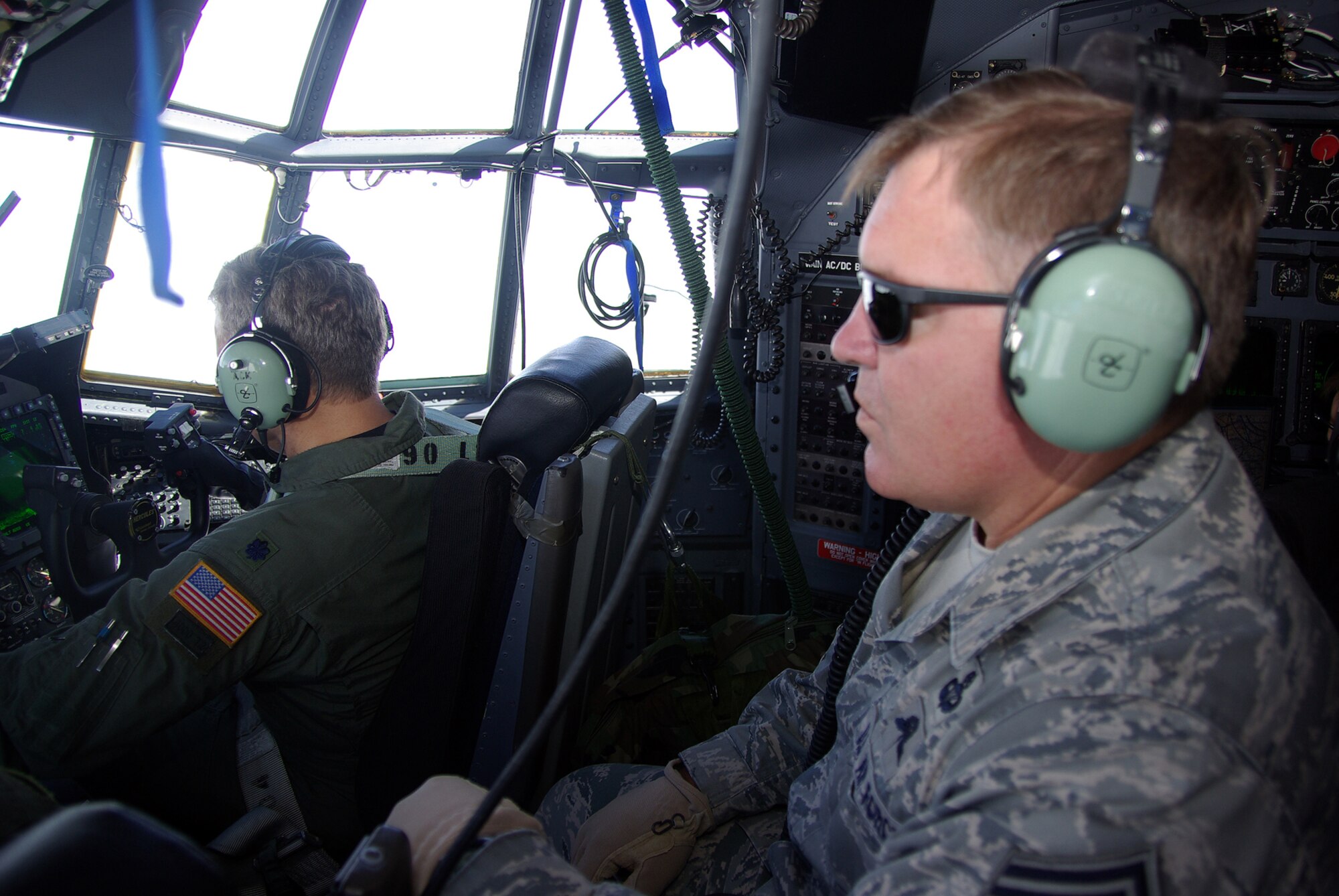 RAF MILDENHALL, England -- Chief Master Sgt. Michael Gilbert, Air Force Special Operations Command command chief, gets the bird’s-eye view from the flight engineer seat in an MC-130H Combat Talon II preceding his jump from that aircraft.  Chief Gilbert recently visited members of the 352nd Special Operations Group here, where he conducted an enlisted call addressing questions regarding manning, training and the way ahead.  (U.S. Air Force photo by Tech. Sgt. Marelise Wood)