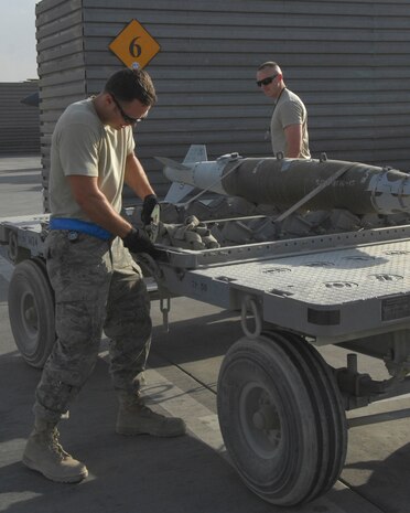 BAGRAM AIRFIELD, Afghanistan – Providing weapons for the fight, Staff Sgt. Todd Wolf, a Saint Joseph, Mo. native now deployed from Charleston Air Force Base’s 437th Maintenance Squadron in South Carolina, works with Airman 1st Class Michael Chiniquy deployed from the 23rd Maintenance Group at Moody AFB, Ga. to deliver weapons to their awaiting A-10 Thunderbolt II, also known as the Warthog.  The A-10 is well-liked by ground commanders in combat due to its high payload, ability to stay on station over targets and the GAU-8 high explosive dispensing cannon in the nose of the aircraft.  The A-10 plays a pivotal role in Afghanistan’s Operation Enduring Freedom. (U.S. Air Force photo/Capt. David Faggard)