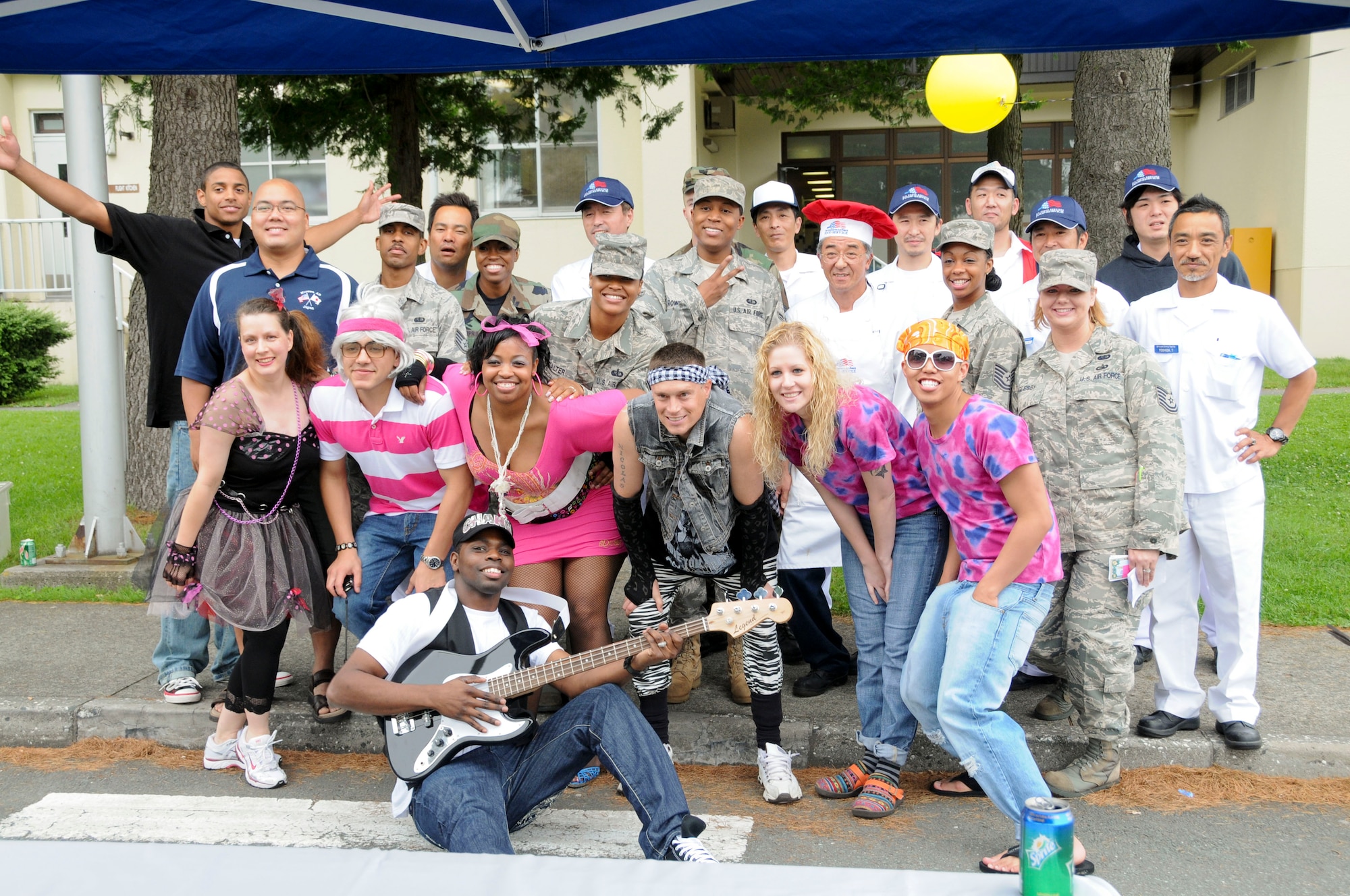 MISAWA AIR BASE, Japan -- Members of the Grissom Dining Facility staff pose for a group photo during an 80's Costume Block Party July 24. The staff hosted the event which offered food, music, games and prizes to Misawa Air Base personnel. (U.S. Air Force photo by Senior Airman Christopher Bevins)