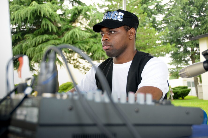 MISAWA AIR BASE, Japan -- Staff Sgt. Joseph Chaney, 35th Force Support Squadron, disc jockeys during the Grissom Dining Facility's 80's Costume Block Party July 24. Aside from music, the event offered food, games and prizes. (U.S. Air Force photo by Senior Airman Christopher Bevins)