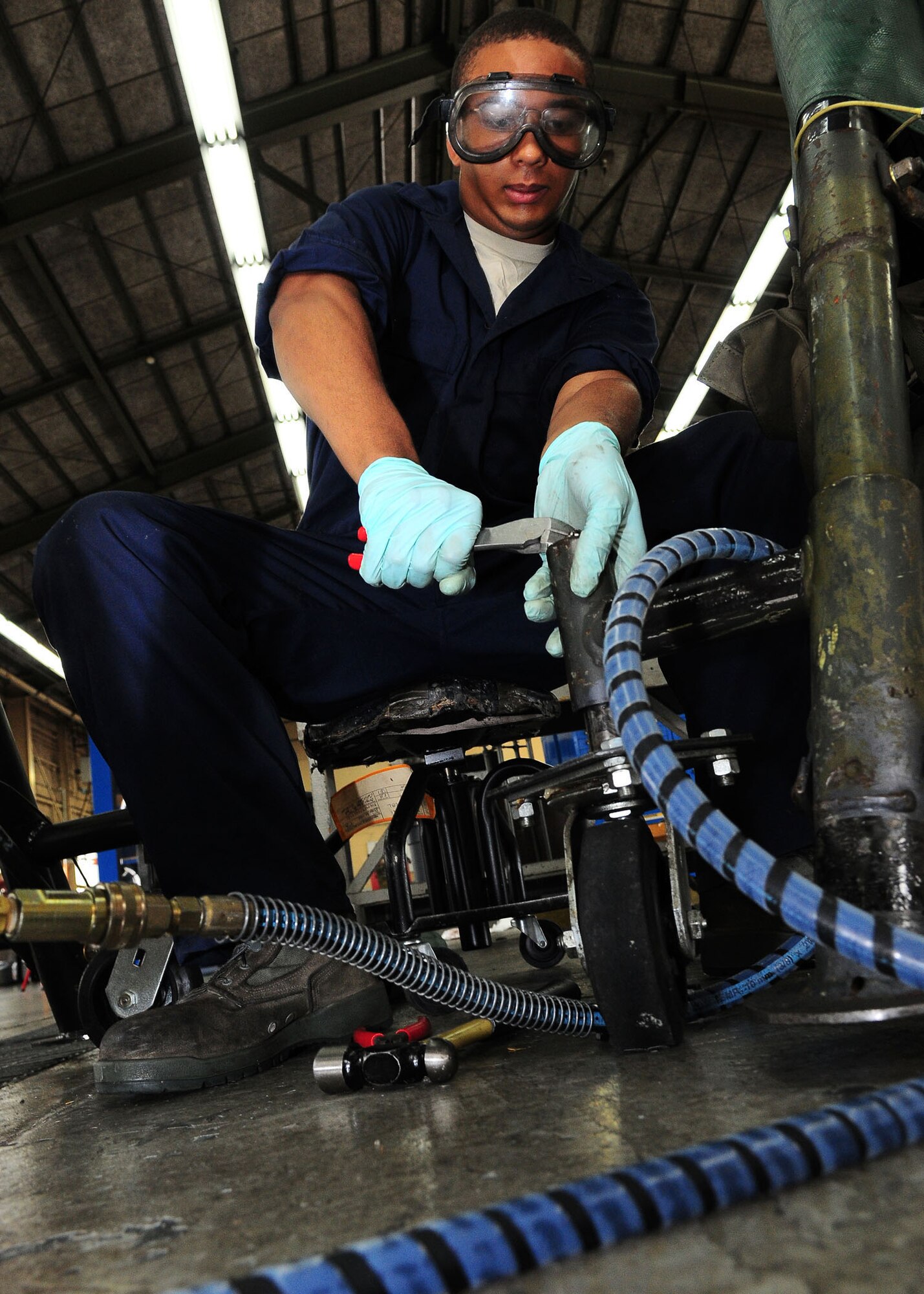 YOKOTA AIR BASE, Japan -- Airman 1st Class Michael Payne, 374th Maintenance Squadron Aerospace Ground Equipment Flight, works on an aircraft nose cone dolly July 23. Members of the AGE flight support the base's flying mission by maintaining more than 600 pieces of ground support equipment. (U.S. Air Force photo/Airman 1st Class Michael Dillon)