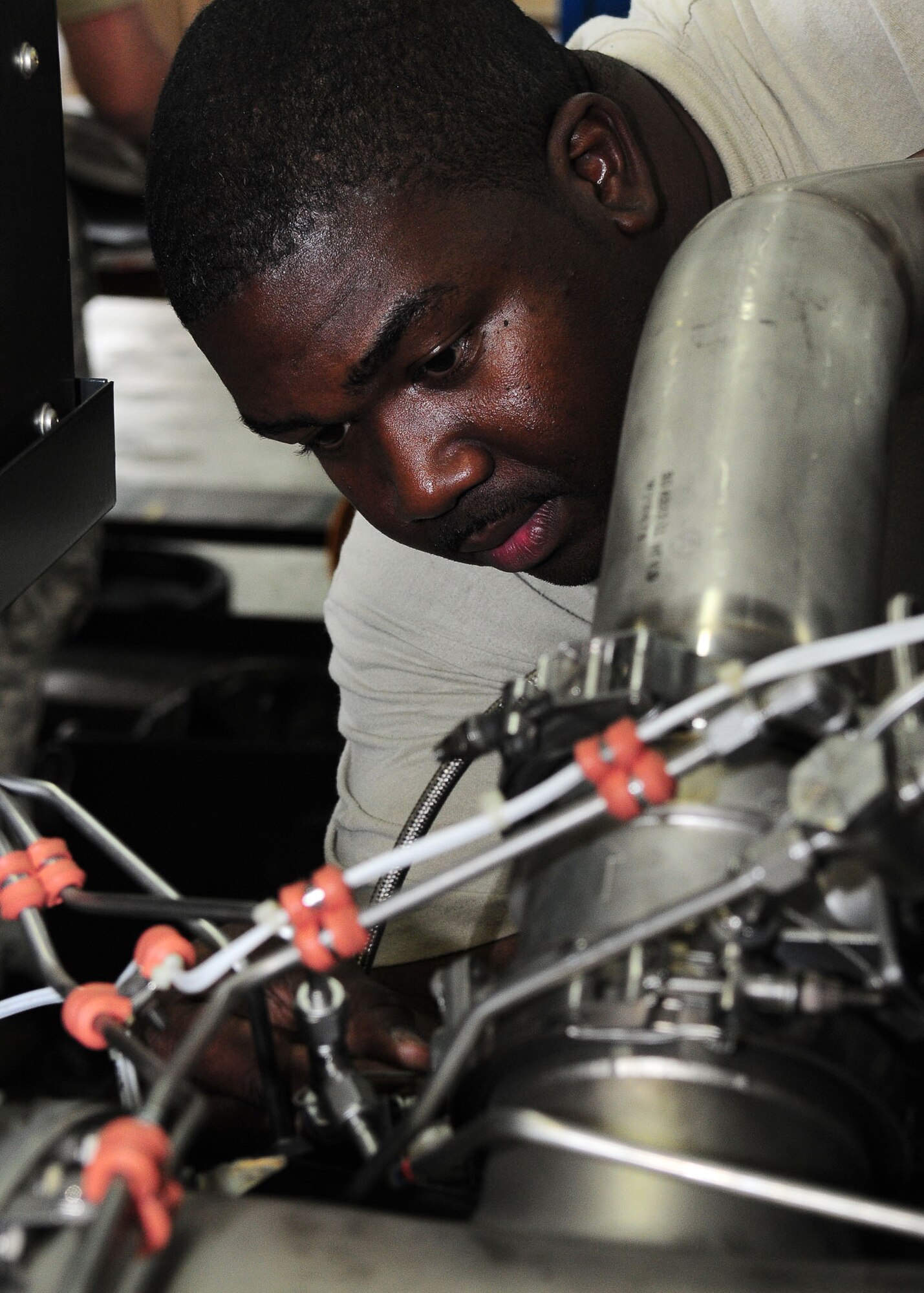YOKOTA AIR BASE, Japan -- Tech Sgt. Cedric Smith, 374th Maintenance Squadron Aerospace Ground Equipment Flight, checks safety wire on a turbine compressor July 23. Members of the AGE flight support the base's flying mission by maintaining more than 600 pieces of ground support equipment. (U.S. Air Force photo/Airman 1st Class Michael Dillon)