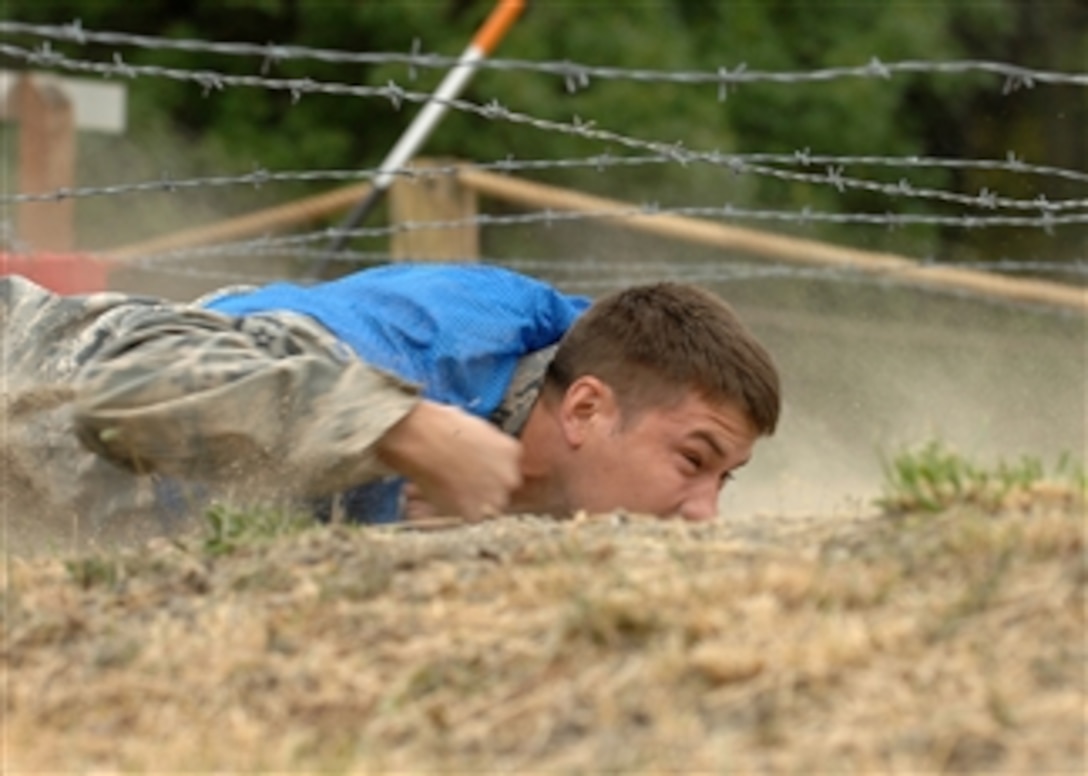 A U.S. Air Force airman from the Dyess Air Force Base, Texas, security forces team maneuvers underneath barbed wire while competing in the Security Forces Endurance Course for Air Mobility Rodeo 2009 at McChord Air Force Base, Wash., on July 23, 2009.  Rodeo is an international combat skills and flying operations competition designed to develop and improve techniques and procedures among international partners.  