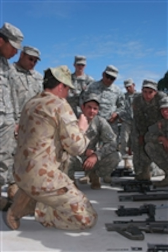 U.S. Army soldiers with Charlie Company, 1st Battalion, 160th Infantry Regiment receive a period of instruction from an Australian soldier bombardier with A12 Medium Regiment Battery on how to field strip an F88 Austeyr rifle at Shoalwater Bay Training Area, Australia, during Exercise Talisman Sabre 2009 on July 20, 2009.  Talisman Sabre 09 is a combined training activity designed to train Australian and U.S. forces in planning and conducting combined task force operations that will improve combat readiness and interoperability.  
