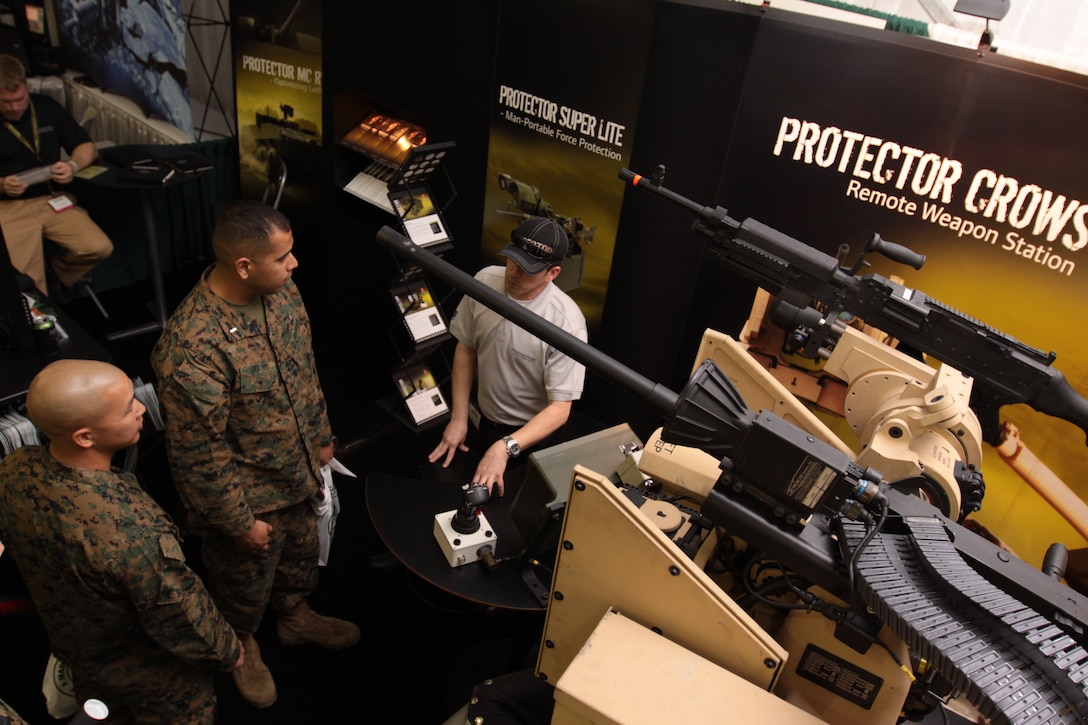John Carlsson, Kongsberg sales representative, explains the capabilities of the Protector Crows remote weapon station to Marines at the 2011 Marine West Expo at Camp Pendleton Jan. 26. The Expo showcased more than 200 vendors to more than 3,500 visitors and highlighted the best of what deployed Marines are using and will use in years to come.