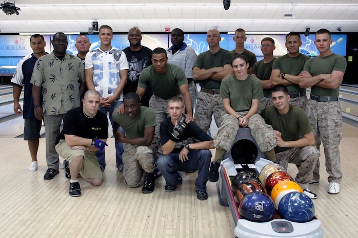 Marine Aviation Logistics Squadron 12 Marines and civilian contractors pose for a group picture before kicking off the final MALS-12 Bowling League game at the Strike Zone here July 28. The bowling league members played during lunch twice a week for approximately 23 weeks at the bowling center before playing the championship games.