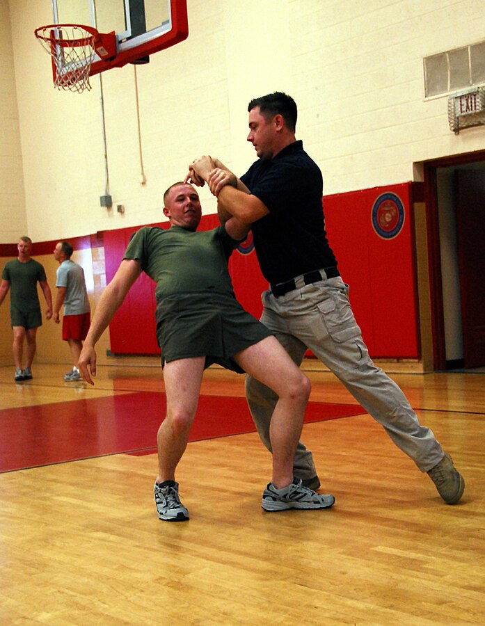 Officer Timothy Alrashedy practices a control hold technique on fellow military policeman Pfc. Logan Griffith during training in the gym at the Marine Corps Air Station in Yuma, Ariz., July 28, 2009. The provost marshal’s office trained its MPs to control combative subjects by manipulating their momentum, body mechanics and leverage.