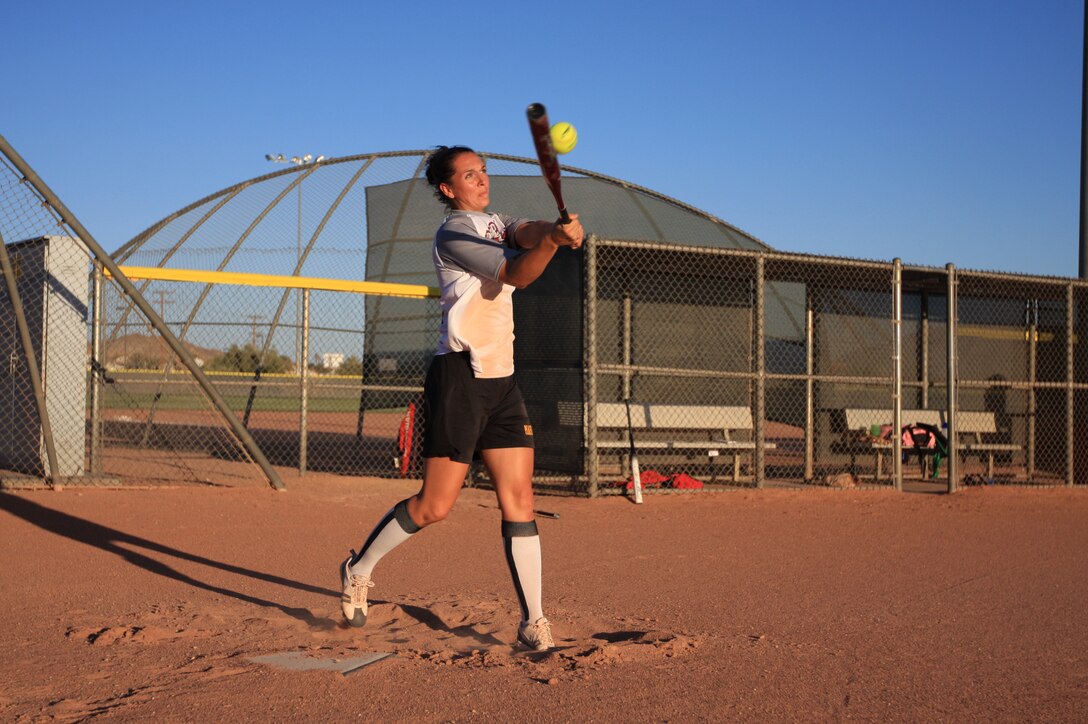 Capt. Ruth Wilson, the data training section officer in charge for the Marine Corps Communications-Electronics School, makes a direct hit during the All-Marine Women's Softball Team screening July 29 at Felix Field.