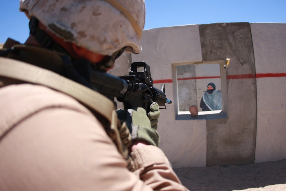 Shell casings fly as Cpl. Matt McCaskill picks off enemy targets July 29, at Combat Center Range 111. McCaskill is a military policeman with the Combat Center's Provost Marshal's Office's Special Reaction Team, which trained in urban warfare on Range 111.