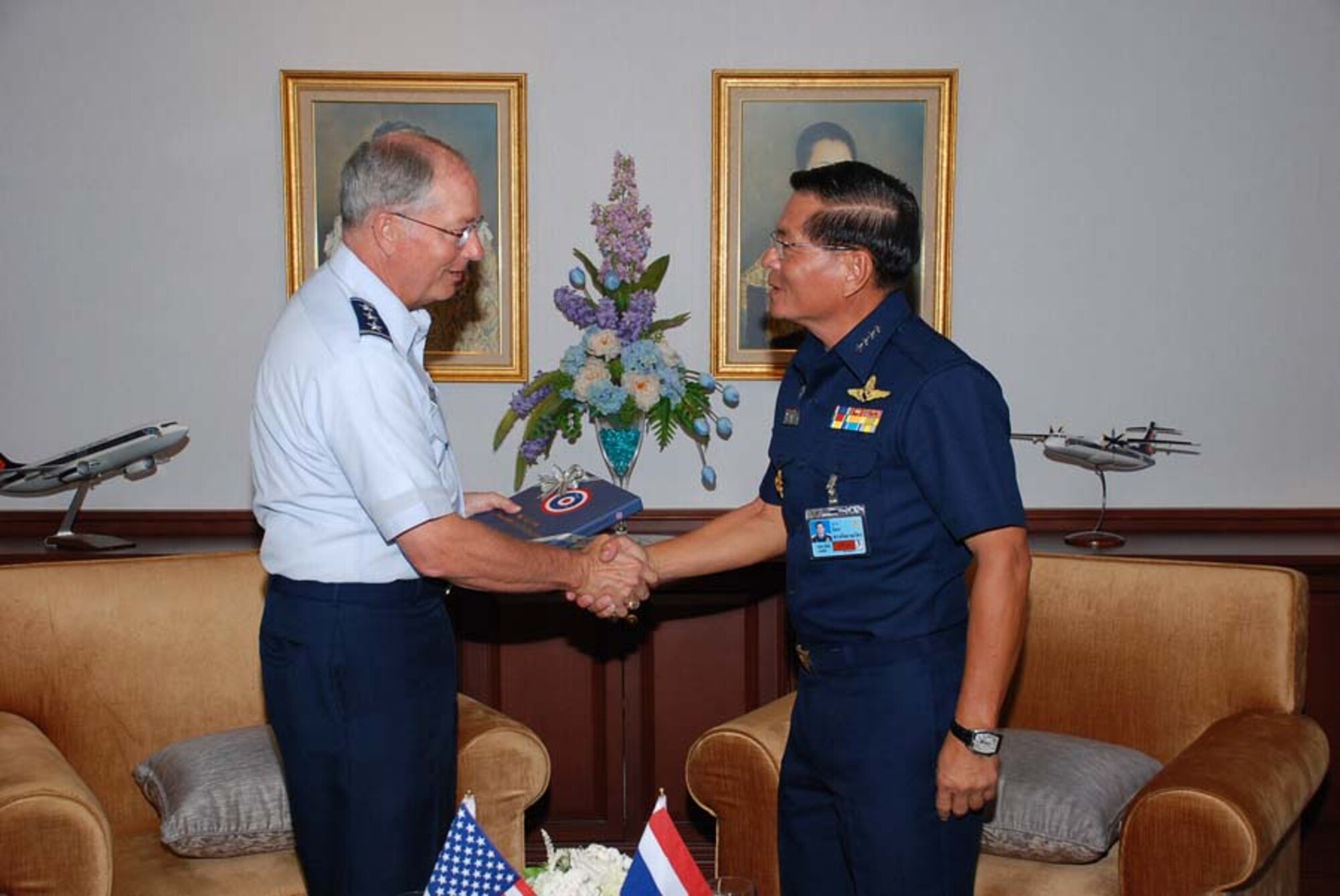 BANGKOK, Thailand -- Lt. Gen. Chip Utterback, 13th Air Force commander at Hickam Air Force Base, Hawaii, shakes hands with Air Chief Marshall Dilok Songgalayanawat, Royal Thai Air Force Assistant Commander in Chief, during a visit here July 21.  The two leaders discussed upcoming partnering activities between the U.S. and Thai air forces, including the Cope Tiger exercise held annually in Thailand.  (Courtesy photo)