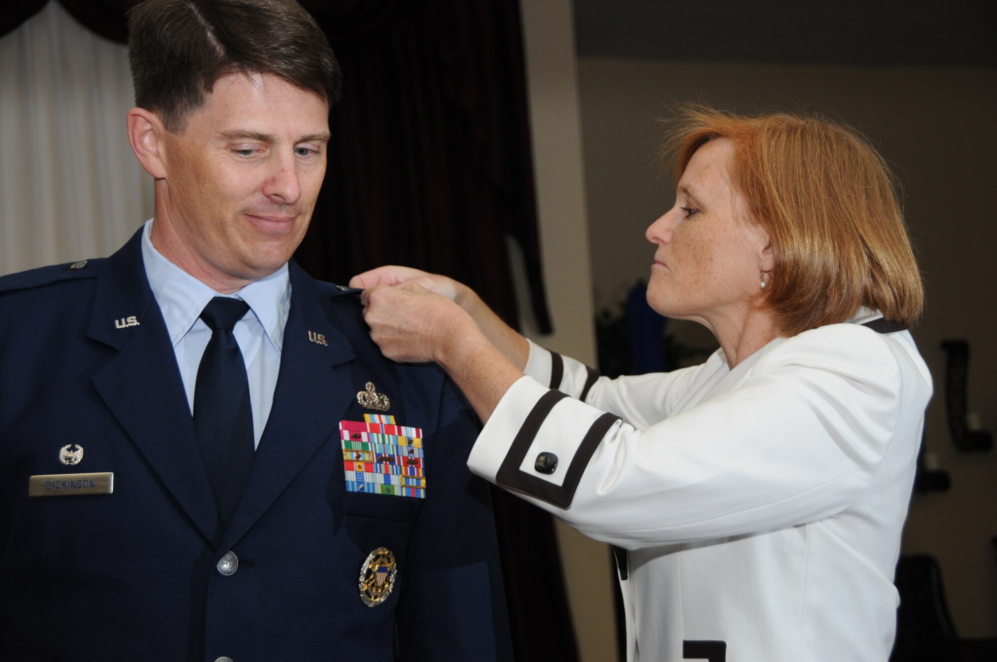 JJ Dickinson pins a star on her husband, Brig. Gen. Brig. Ian Dickinson, at his promotion ceremony at the Dragon's Lair, July 20.  The general is commander of the 81st Training Wing.  (U.S. Air Force photo by Kemberly Groue)