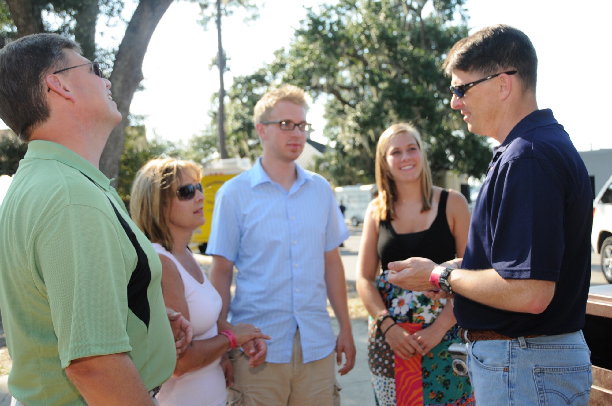 From left, Nick, Deb, Zach and Abby Norman chat with Brig. Gen. Ian Dickinson, 81st Training Wing commander, at a reception at marina park following his promotion ceremony, July 20.  Mrs. Norman is General Dickinson's cousin.  (U.S. Air Force photo by Kemberly Groue)