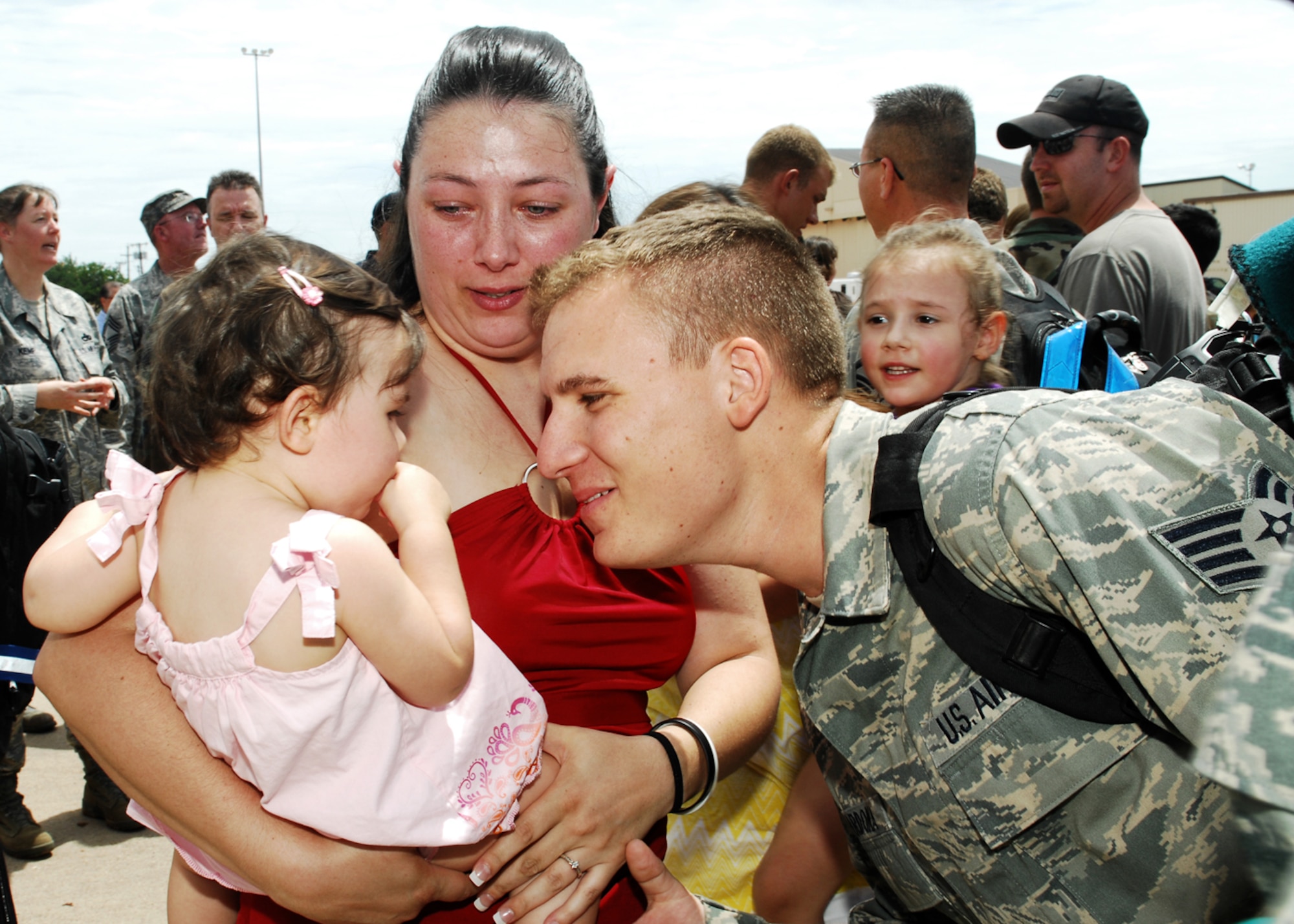 Staff  Sgt. Kory Cardona, 7th Aircraft Maintenance Squadron, greets his family here July 29 after returning from a six month deployment to Southwest Asia. More than 300 Airmen from the 9th Bomb Squadron, 7th Operations Support Squadron, 7th Maintenance Group and 7th Medical Group were deployed supporting Operations Iraqi and Enduring Freedom. (U.S. Air Force photo by Airman 1st Class Chelsea L. Browning)