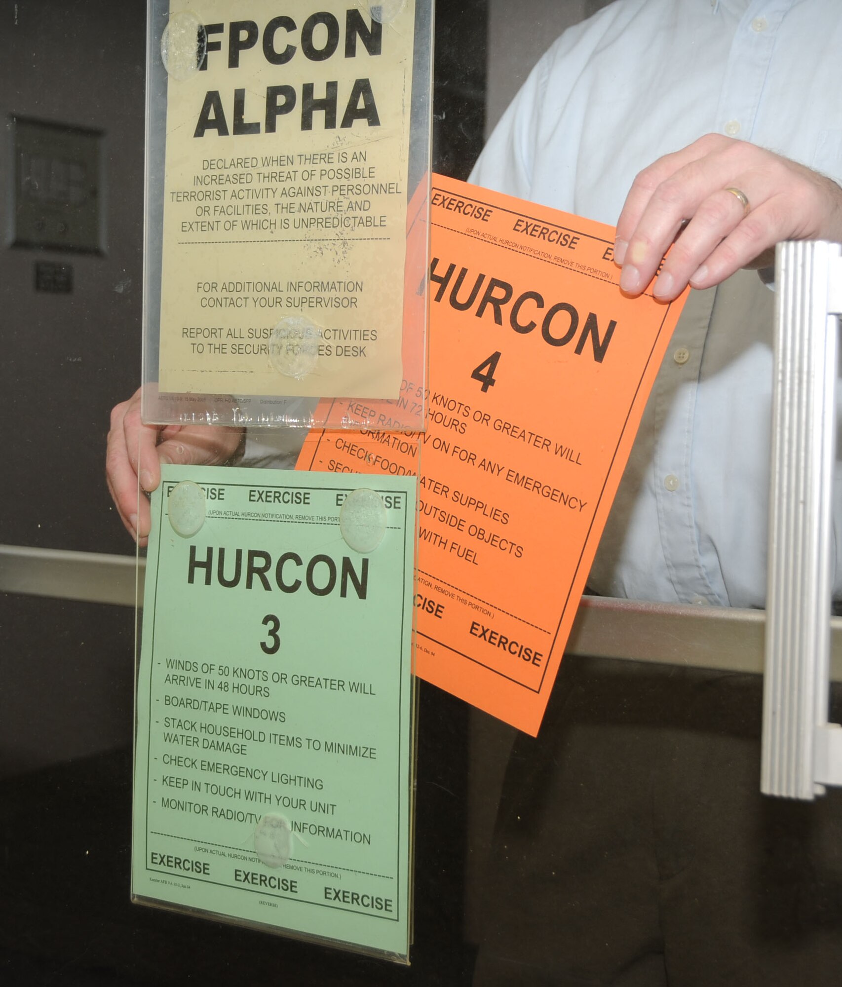 Door signs were changed as hurricane conditions intensified during the exercise.  (U.S. Air Force photo by Kemberly Groue)
