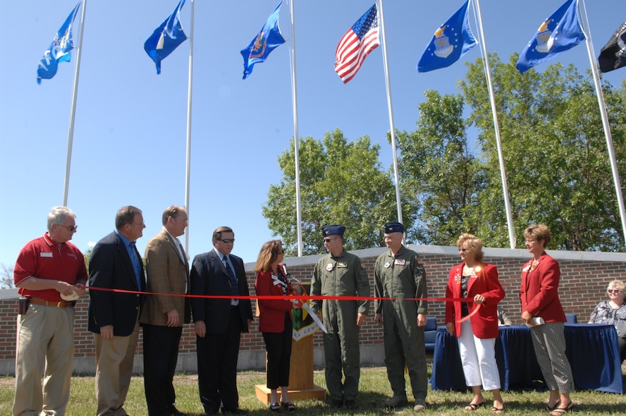 MINOT AIR FORCE BASE, N.D. -- Col. Julian Tolbert, 5th Bomb Wing vice commander and Col. Michael Spencer, 91st Missile Wing vice commander, gather together at Minot Air Force Base with Minot City Officials, to celebrate the new addition to the base.  Minot Air Force Base is welcoming the new flag display at its front gate, and celebrating the occasion with a ribbon cutting. (U.S. Air Force Photo by Staff Sgt. Stacy Moless)
