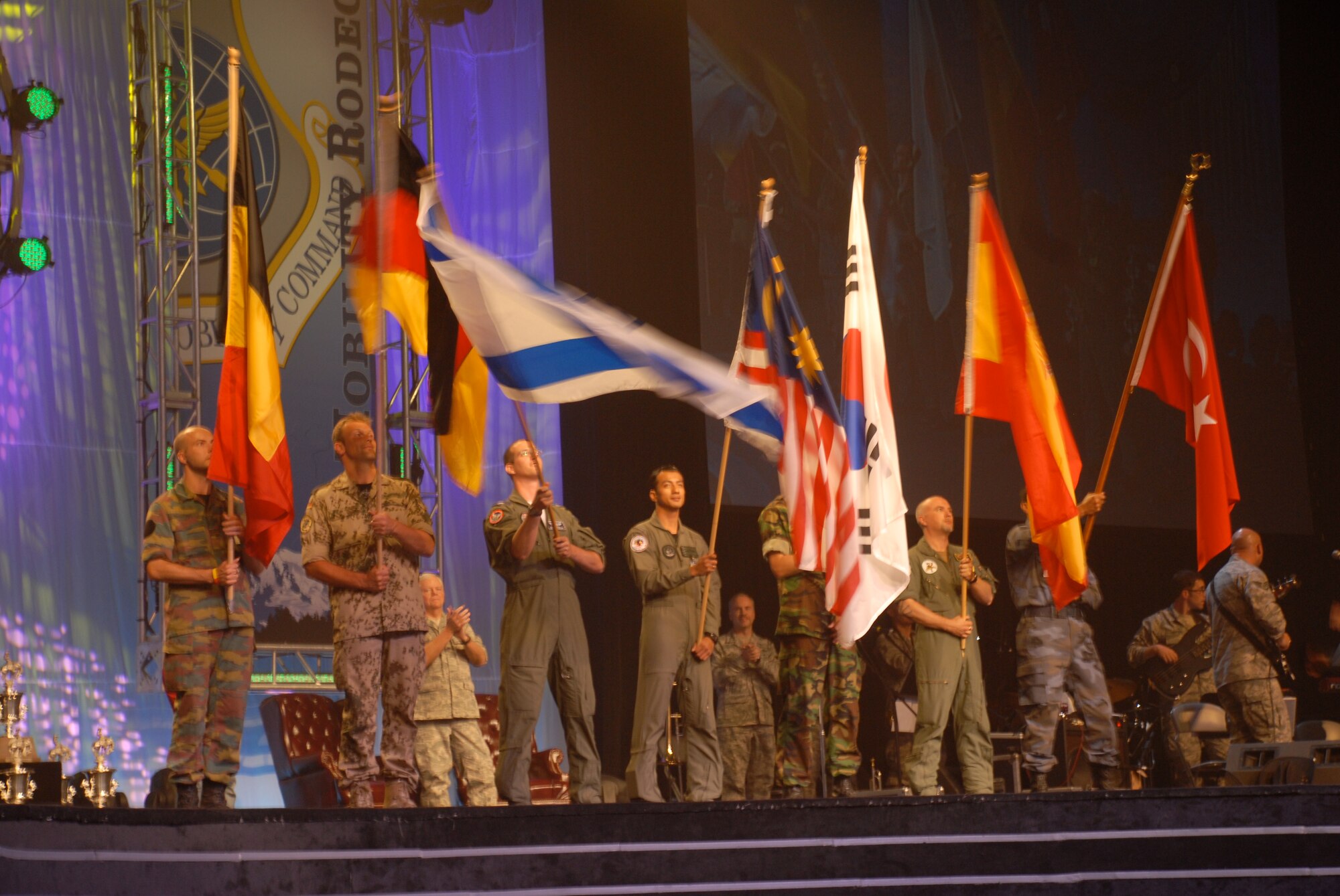 MCCHORD AIR FORCE BASE, Wash. – International representatives of allied nations who participated in the Air Mobility Rodeo 2009 wave their countries’ flags during closing ceremonies here July 24. Flight crew members, maintainers, security forces, and joint airdrop inspection specialists here competed against more than 100 teams and 2,500 people from the Air Force and allied nations at this biennial, international competition July 19-25 at McChord Air Force Base, Wash. The units competed in events that tested and judged every aspect of their career fields' core competencies. The Rodeo is designed to demonstrate air mobility mission capabilities, seek out new tactics, techniques, and procedures that improve mission results, increase esprit de corps both among competing teams and internationally, and build standardization and safety. (U.S. Air Force photo/Staff Sgt. Carolyn Viss) 