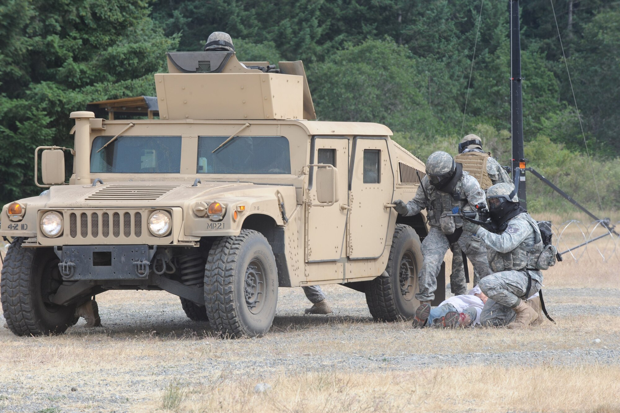 MCCHORD AIR FORCE BASE, Wash. -- Members from Team McConnell’s RODEO security forces team provide cover while pulling the simulated wounded informant during the RODEO combat tactics competition, July 20. The team reacted to scenarios testing their tactic skills, clearing procedures and other skills such as self-aid buddy care.  (Photo by Tech. Sgt. Chyrece Campbell)  