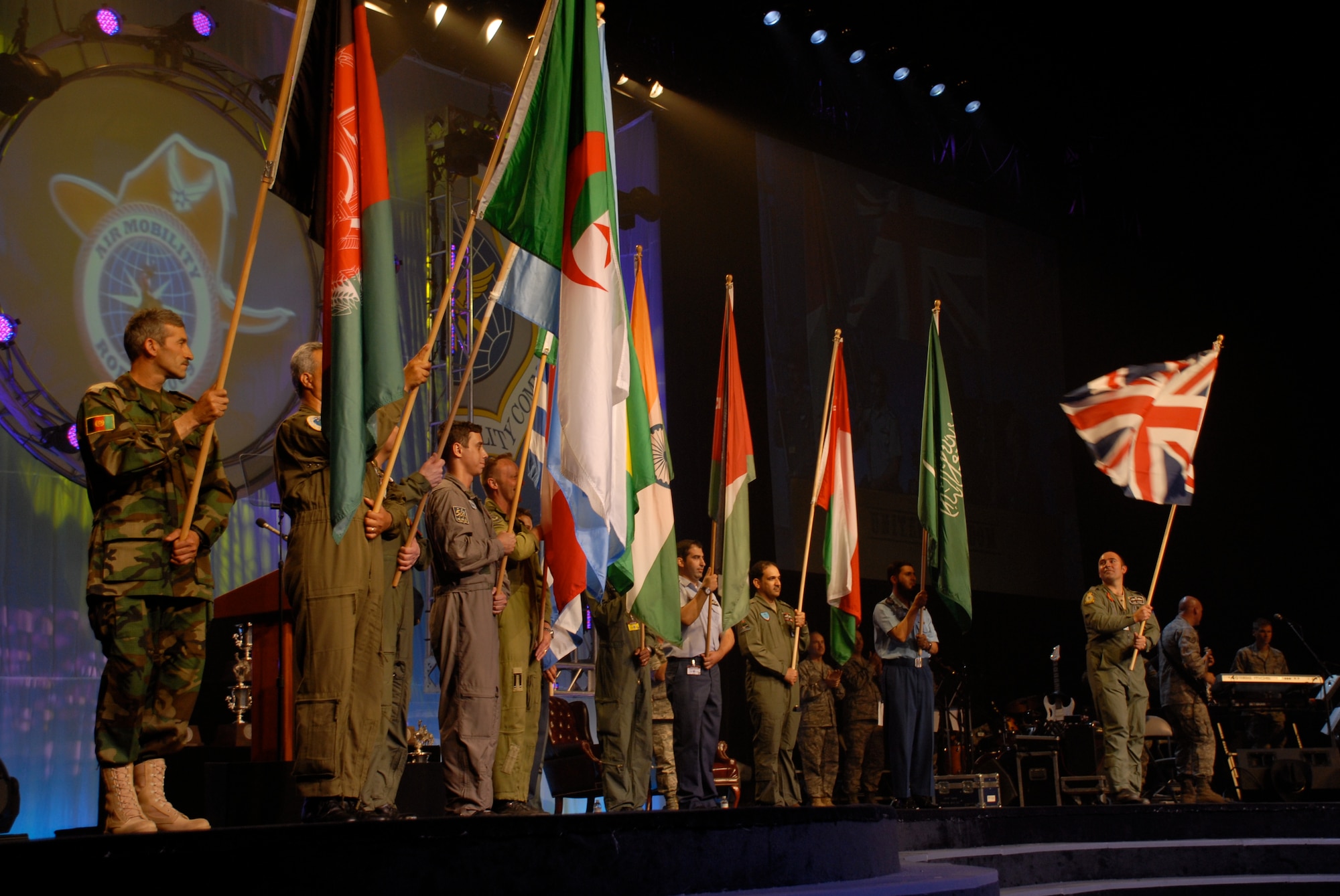 MCCHORD AIR FORCE BASE, Wash. – International representatives of allied nations who observed the Air Mobility Rodeo 2009 wave their countries’ flags during closing ceremonies here July 24. Flight crew members, maintainers, security forces, and joint airdrop inspection specialists here competed against more than 100 teams and 2,500 people from the Air Force and allied nations at this biennial, international competition July 19-25 at McChord Air Force Base, Wash. The units competed in events that tested and judged every aspect of their career fields' core competencies. The Rodeo is designed to demonstrate air mobility mission capabilities, seek out new tactics, techniques, and procedures that improve mission results, increase esprit de corps both among competing teams and internationally, and build standardization and safety. (U.S. Air Force photo/Staff Sgt. Carolyn Viss) 