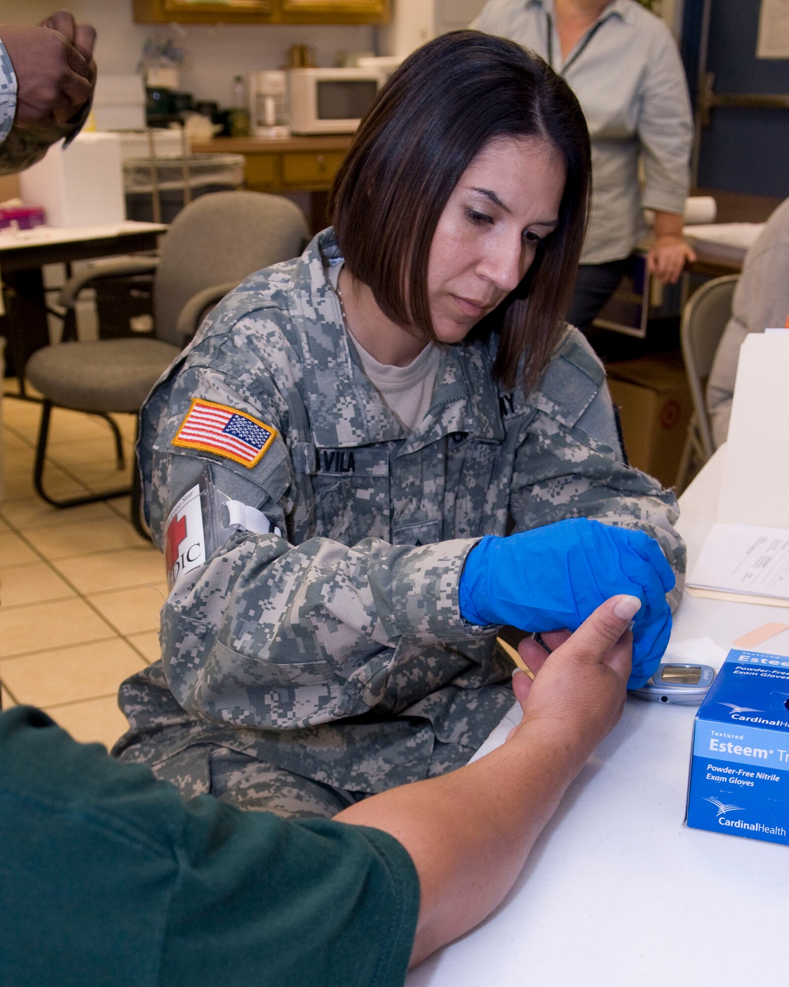 U.S. Army Sgt. Samantha Davila prepares to get a little blood  for a blood glucose check at the Medical Innovative Readiness Team Site (MIRTS) located at the LaSara Community Resource Center in LaSara, Texas during Operation Lone Star.  Operation Lone Star is a Joint Civilian/Military Medical mission offering free Medical care to the region,  29 July 2009.(USAF Photo by Master Sgt. Michael Lachman) 