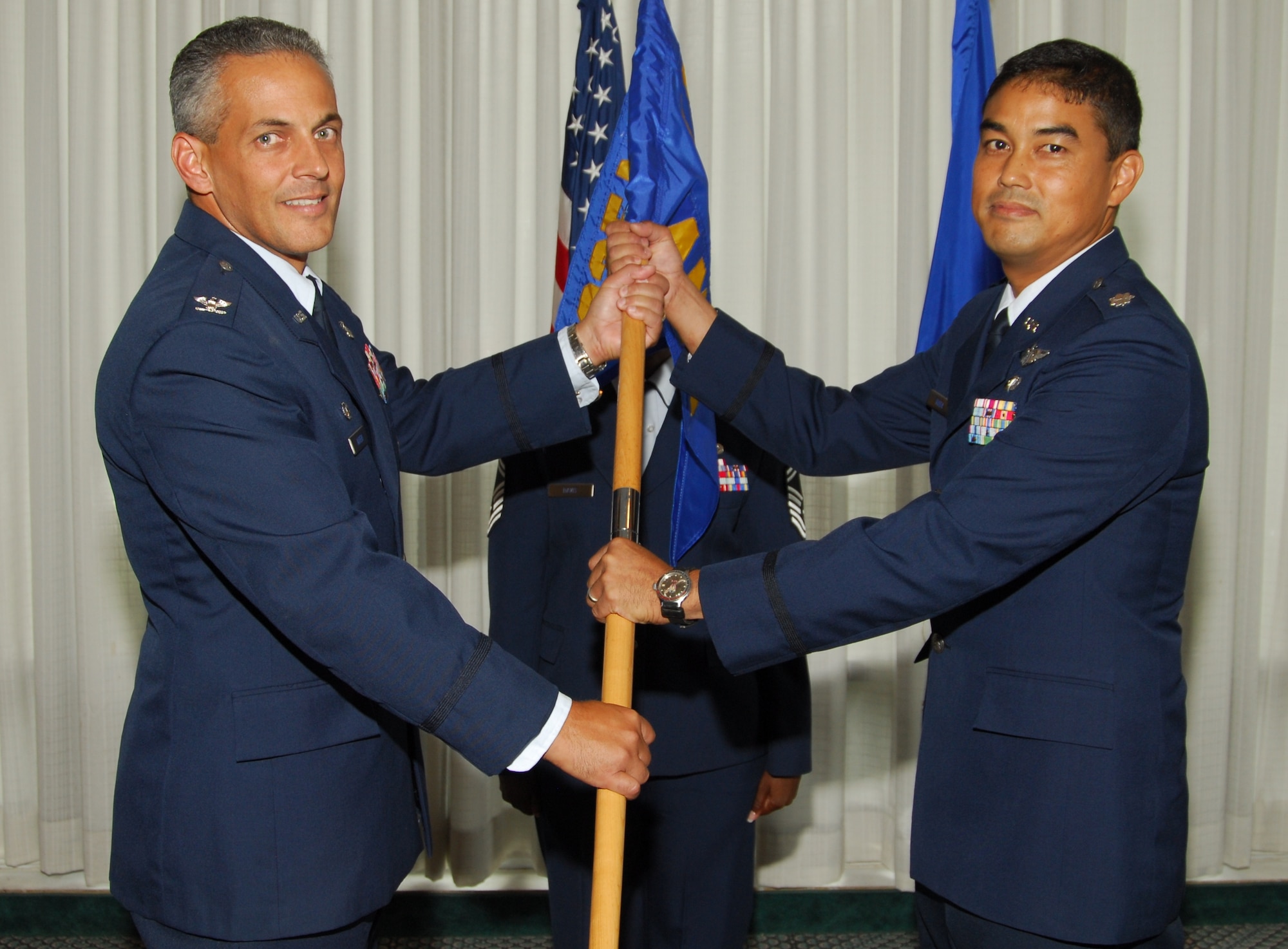 (Left) Col. Gino Auteri, 325th Medical Group commander, presents the guidon to Lt. Col. Erik Koda, as he takes command of the 325th Aero-Medical Dental Squadron. The change of command ceremony took place July 29 at the Heritage Club. (U.S. Air Force photo/Lisa Norman)
