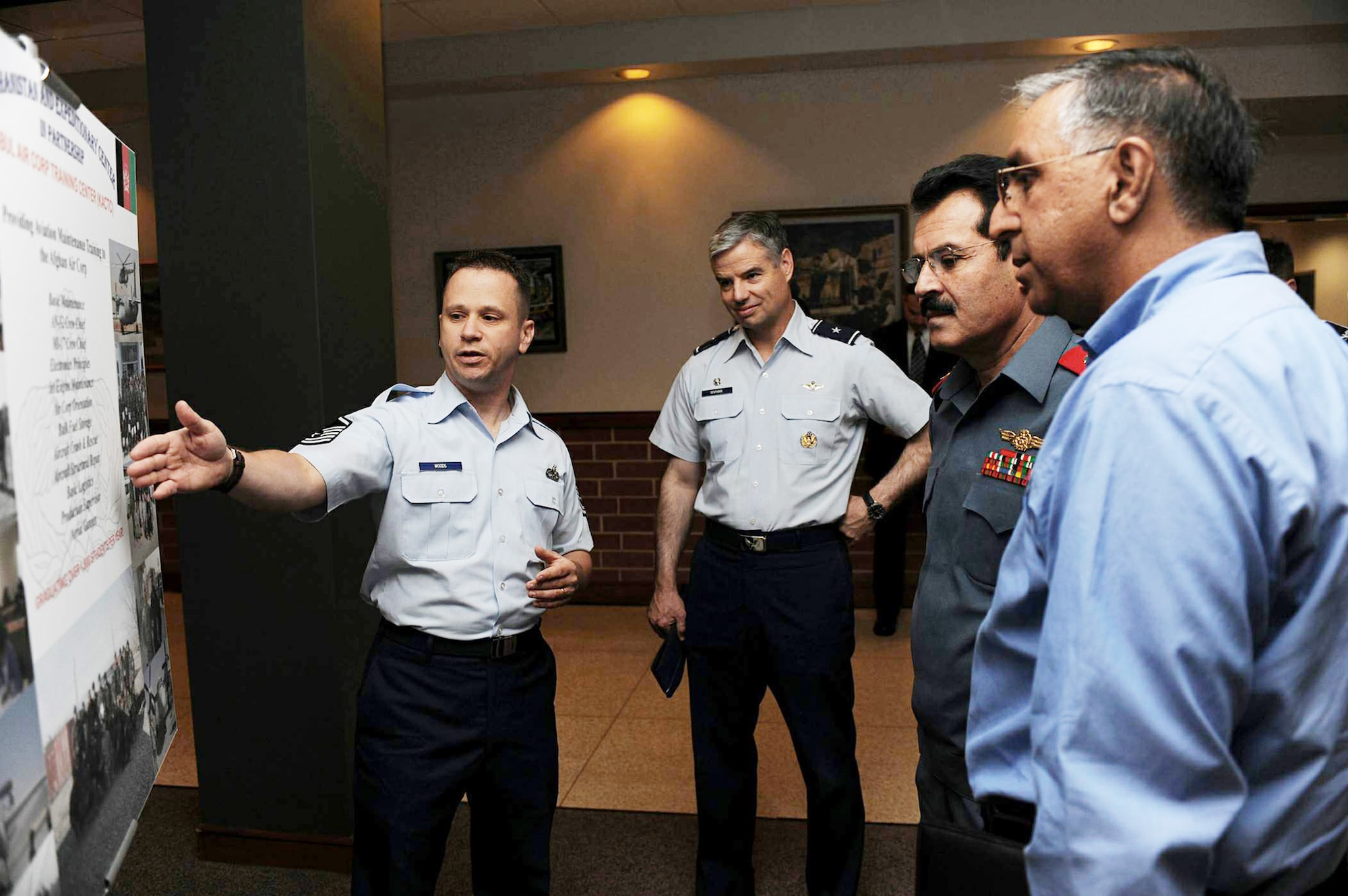 Master Sgt. Richard Woods (left) explains a storyboard July 13 at the Air Force Expeditionary Center on Joint Base McGuire-Dix-Lakehurst, N.J. The briefing was part of a visit here by Afghan Maj. Gen. Mohammad Dawran, commander of the Afghanistan National Army Air Corps, to learn more about the Air Education and Training Command's Air Adviser Course housed here. Also shown are Brig. Gen Walter Givhan, the Combined Air Power Transition Force commanding general (second from left); and M. Monir Rafiq, a Department of Defense interpreter (far right). (U.S. Air Force photo/Staff Sgt. Nathan G. Bevier) 