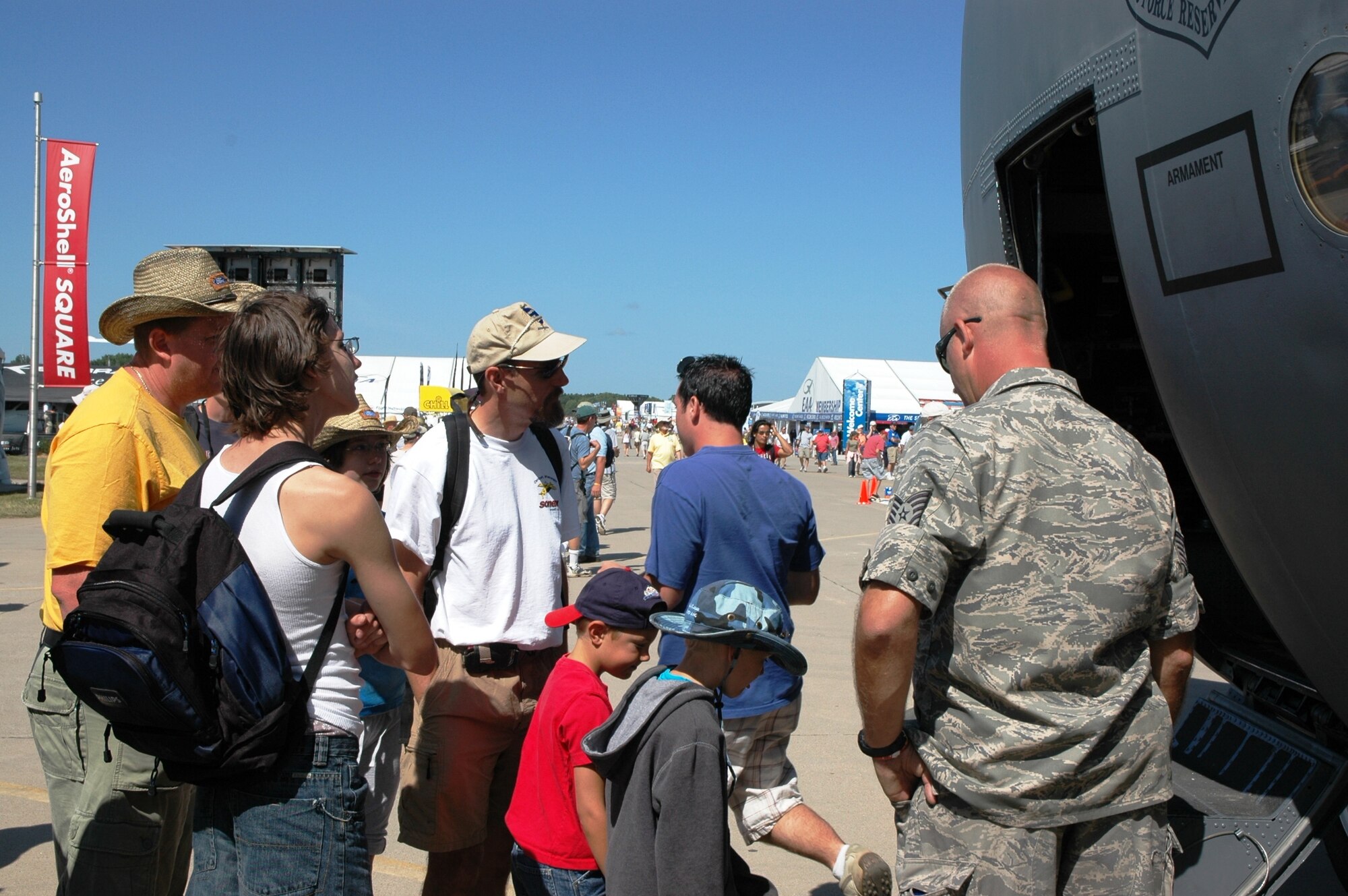An Air Force Reserve maintainer answers questions from spectators July 29 about the Modular Airborne Firefighting System, or 'MAFFS II,' at the 2009 Experimental Aircraft Association AirVenture air show in Oshkosh, Wis. The AF Reserve's 302nd Airlift Wing, participated in this year's air show by demonstrating the new MAFFS II capabilities on July 27 with a live air drop. The air show is known as the world's greatest aviation celebration and attracts hundreds of thousands of aviation enthusiasts from all over the world. The C-130, assigned to the 302nd AW at Peterson Air Force Base, Colo., is equipped with the new MAFFS II system and is on display at EAA AirVenture through July 29. (U.S. Air Force photo/Capt. Jeff Schoen)