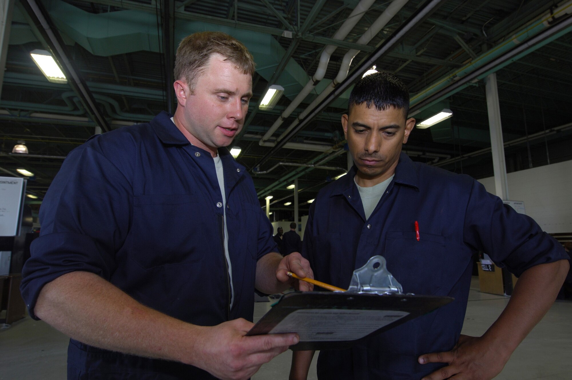 MINOT AIR FORCE BASE, N.D.-- Tech. Sgt. Vincent Hodgdon, 5th Maintenance Squadron Aerospace Ground Equipment (AGE) floor leader, reviews the daily schedule with Staff Sgt. Esteban Rivera VI, here July 27.  The AGE flight recently initiated an Air Force Smart Operations 21 process to increase the unit’s efficiency to meet the bases mission.  The $325.00 cost investment is expected to yield a return of 60 saved man hours weekly and over $1 million annually.   (U.S. Air Force photo by Tech. Sgt.  Lee A. Osberry Jr.)