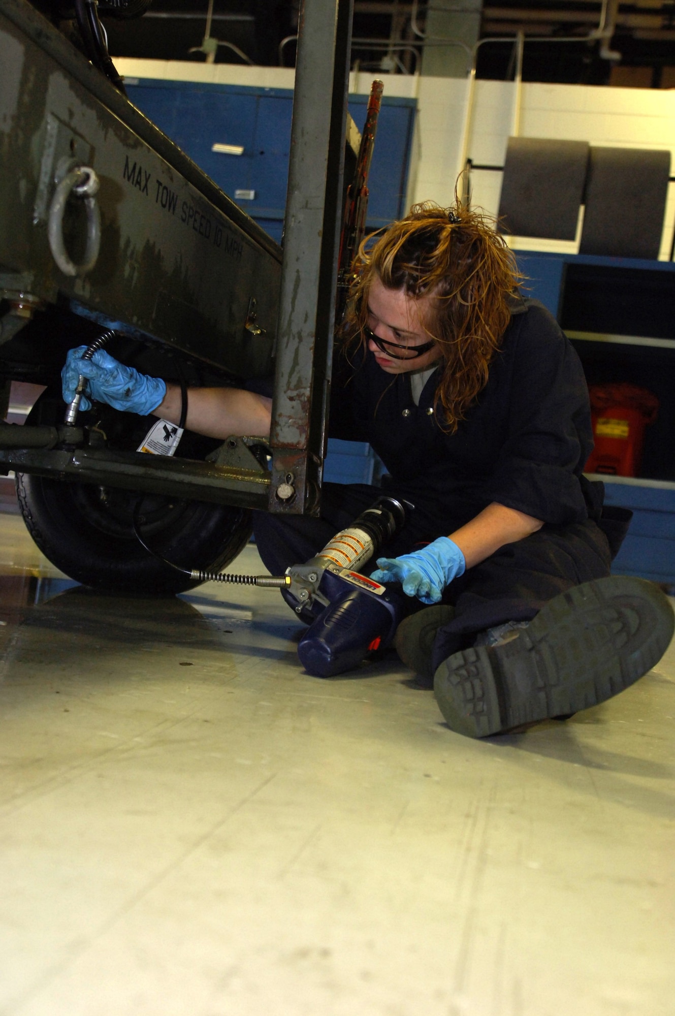 MINOT AIR FORCE BASE, N.D.-- Airman 1st Class Jodi Ebnit, 5th Maintenance Squadron Aerospace Ground Equipment (AGE) technician, prepares to fill the oil on a dash 95 large airstart system here, July 27.  The AGE flight recently initiated an Air Force Smart Operations 21 process to increase the unit’s efficiency to meet the base’s mission.  The $325.00 cost investment is expected to yield a return of 60 saved man hours weekly and over $1 million annually.   (U.S. Air Force photo by Tech. Sgt.  Lee A. Osberry Jr.)