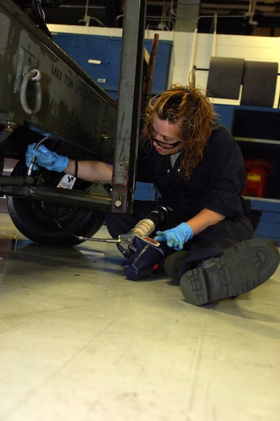 MINOT AIR FORCE BASE, N.D.-- Airman 1st Class Jodi Ebnit, 5th Maintenance Squadron Aerospace Ground Equipment (AGE) technician, prepares to fill the oil on a dash 95 large airstart system here, July 27.  The AGE flight recently initiated an Air Force Smart Operations 21 process to increase the unit’s efficiency to meet the base’s mission.  The $325.00 cost investment is expected to yield a return of 60 saved man hours weekly and over $1 million annually.   (U.S. Air Force photo by Tech. Sgt.  Lee A. Osberry Jr.)