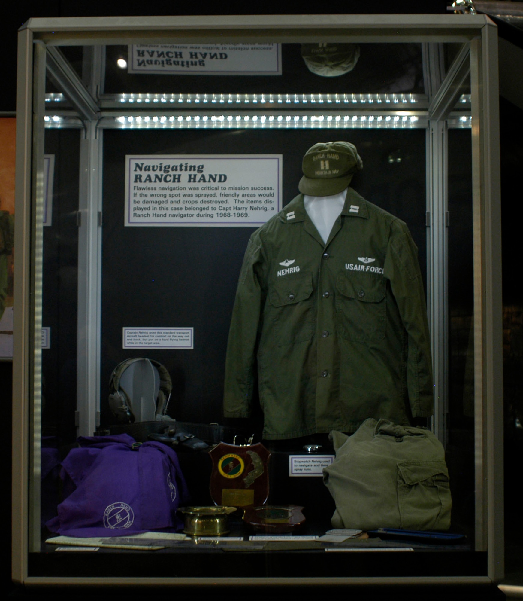 DAYTON, Ohio - Items in the Navigating Ranch Hand case, including an aircraft headset, stopwatch, map, ashtray, plaque and navigation instruments, on display in the Down in the Weeds: Ranch Hand exhibit in the Southeast Asia War Gallery at the National Museum of the U.S. Air Force. (U.S. Air Force photo)