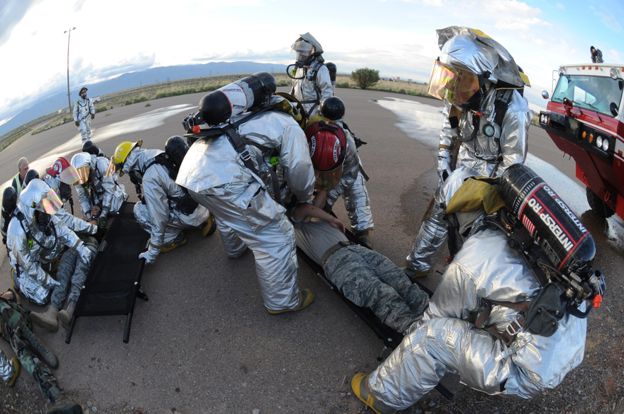 HOLLOMAN AIR FORCE BASE, N.M. -- Holloman Fire Emergency Services act quickly to remove all victims from a simulated C-17 Globemaster III crash during the Major Accident Response Exercise here July 23. After putting out the fire and removing the victims, Explosive Ordinance Disposal personnel were called forth to assess the aircraft and the simulated weapon on board. (U.S. Air Force photo by Airman 1st Class Sondra M. Escutia)