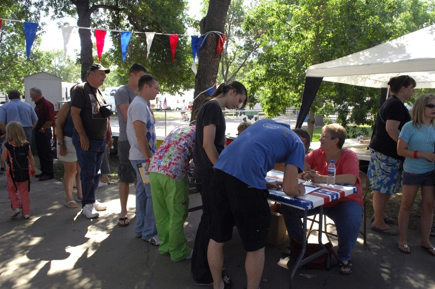 MINOT AIR FORCE BASE, N.D. -- People sign in to enter the Beef Industry Military Appreciation Day, sponsored by the North Dakota Beef Commission, the North Dakota Stockmen’s Association and the North Dakota Cattlewomen, at the 2009 North Dakota State Fair here, July 28. This is the sixth year the beef industry hosted a military appreciation day, having honored more than 5,750 military troops and their families within the last five years. (U.S. Air Force Photo by Airman First Class Jesse Lopez)