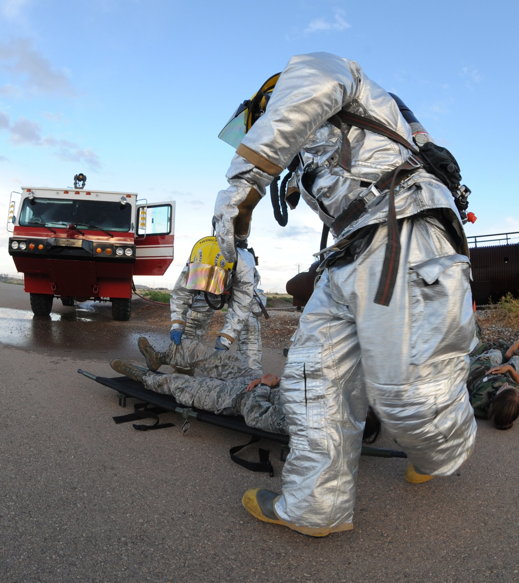 HOLLOMAN AIR FORCE BASE, N.M. -- A member of the Holloman Fire Emergency Services runs to assist his fellow first-responder in a litter transport of a simulated casualty during the Major Accident Response Exercise here July 23. The fire and emergency services personnel were given the opportunity to exercise their readiness during the exercise, as were the command and control units behind the scenes. (U.S. Air Force photo by Airman 1st Class Sondra M. Escutia)