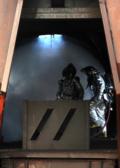 HOLLOMAN AIR FORCE BASE, N.M. -- Two members of Holloman's Fire Emergency Services enter a simulated C-17 Globemaster III and perform an interior search during the Major Accident Response Exercise here July 23. Role-players were placed inside the artificial aircraft who obtained simulated injuries in the exercise scenario. The initial entry team performed triage on the victims before removing them from the aircraft. (U.S. Air Force photo by Airman 1st Class Sondra M. Escutia)