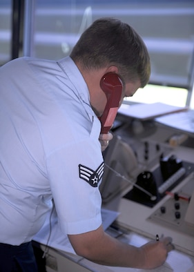 Senior Airman Eli Brown, 4th Operations Support Squadron air traffic controller, ensures the crash phone is functioning in case of emergency on Seymour Johnson Air Force Base, N.C., July 27, 2009. The crash phone is used in the event of an emergency and enables tower personnel to contact first responders. (U.S. Air Force photo by Senior Airman Ciara Wymbs)  