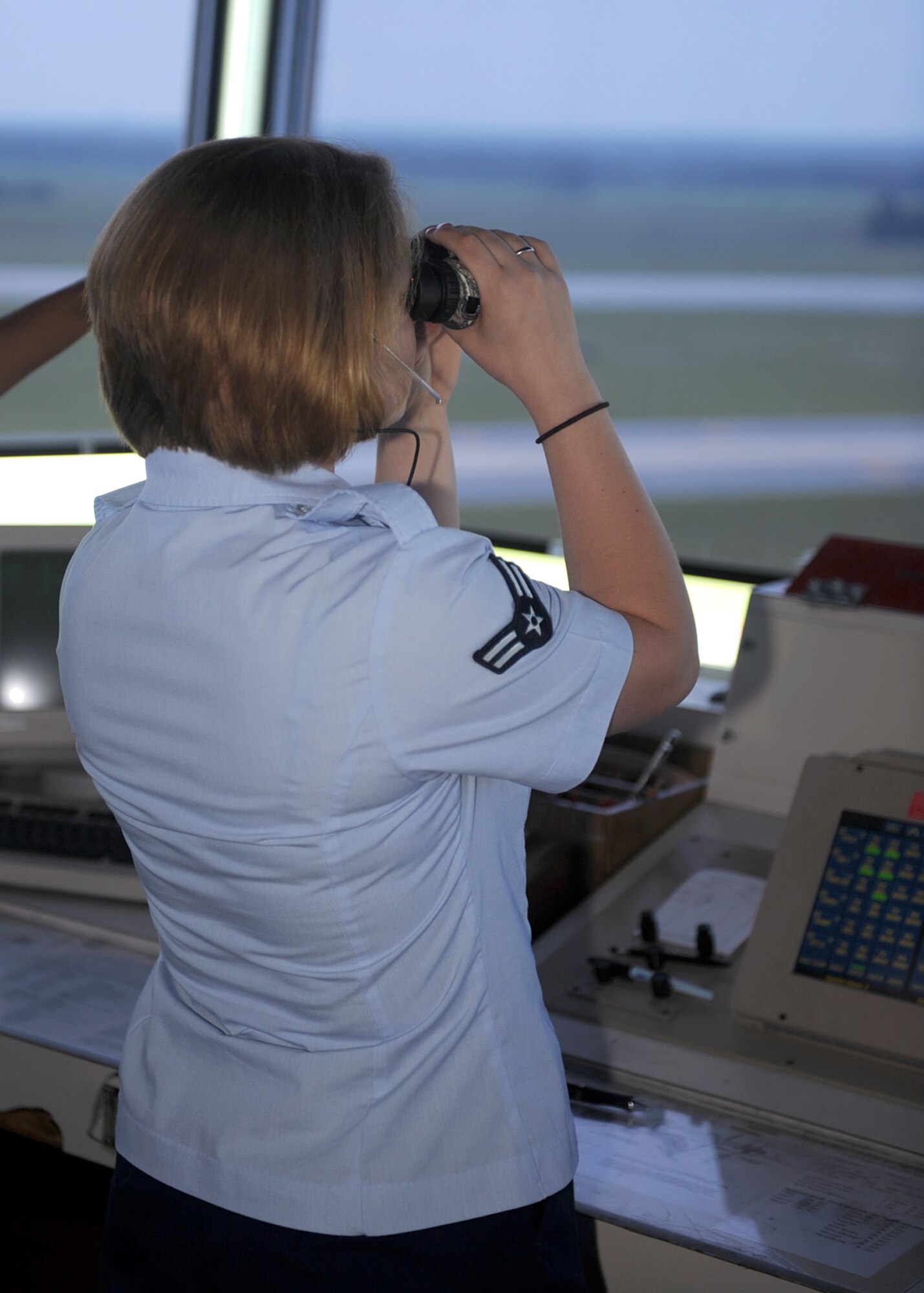 Airman 1st Class Kimberly Zone, 4th Operations Support Squadron air traffic controller, observes the flight line for birds on Seymour Johnson Air Force Base, N.C., July 27, 2009. The fly zones must be constantly scanned to ensure there are no birds in the area that could be swept into an aircraft engine and cause malfunctions. (U.S. Air Force photo by Senior Airman Ciara Wymbs)