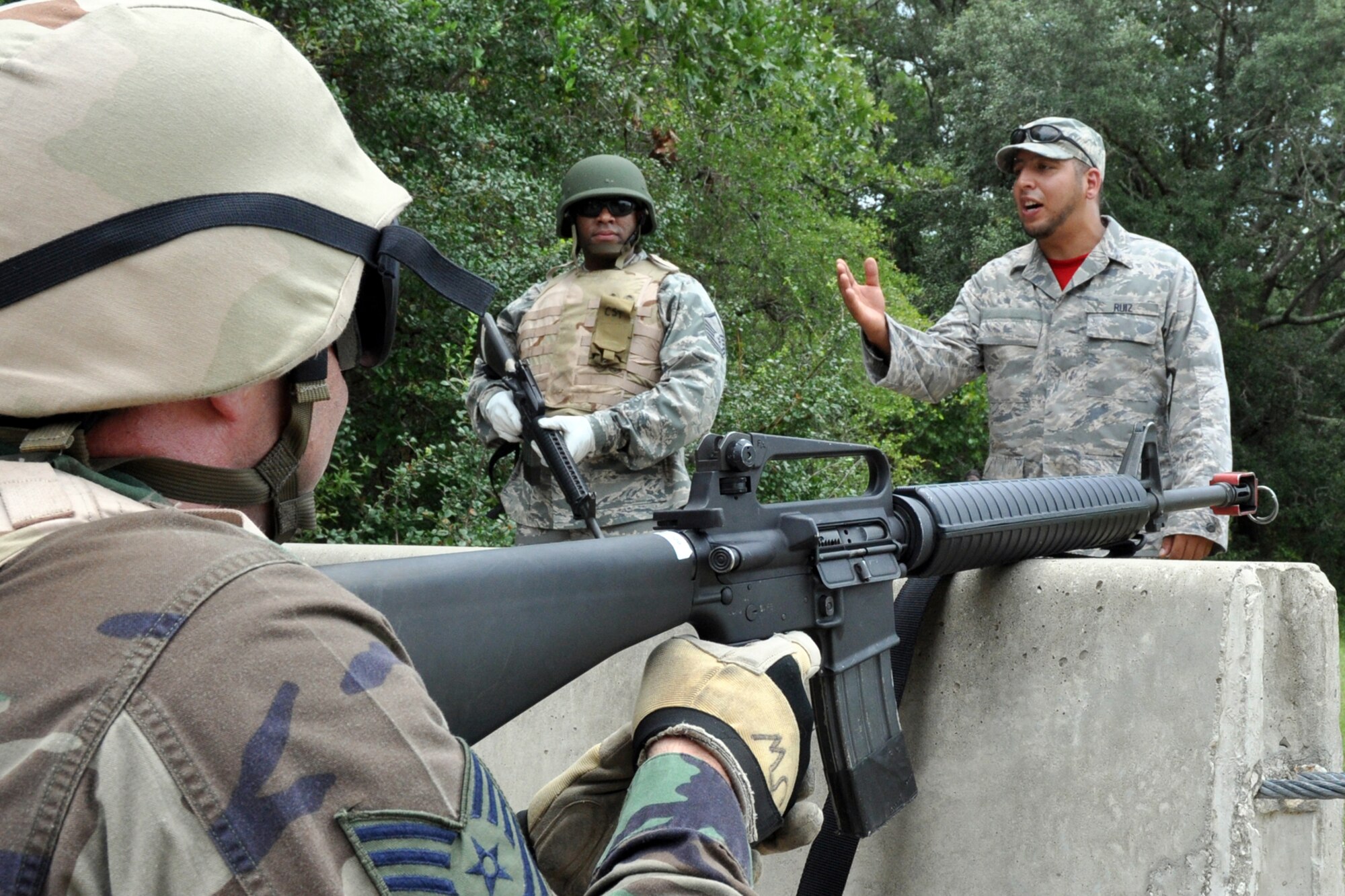 EGLIN AIR FORCE BASE, Fla. -- Airmen rehearse challenging techniques while in a defense fighting position during Combat Skills Training here, July 28. CST is a course that covers everything from use of deadly force to salute reporting and is required for most members as a refresher to prepare them for situations they may encounter in theatre. (U.S. Air Force photo/ Airman Anthony Jennings)