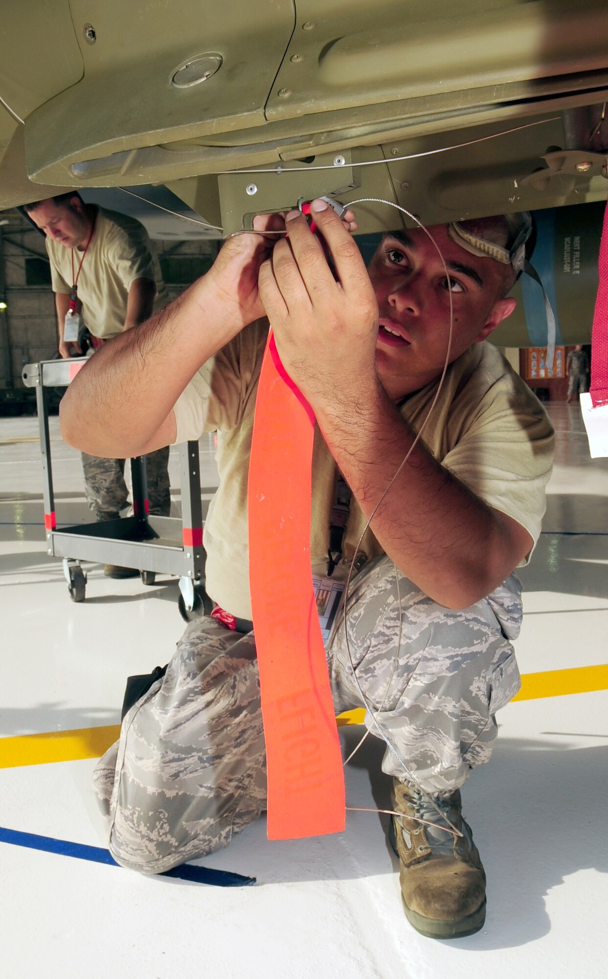 Senior Airman Daniel Diaz, 333rd Aircraft Maintenance Unit weapons load crew chief, installs a safety pin on a practice Mark 82 during a load crew competition at Seymour Johnson Air Force Base, N.C. July 17, 2009. The practice munitions used during this competition are the same size and weight as live munitions. (U.S. Air Force Photo by Airman 1st Class Rae Perry)