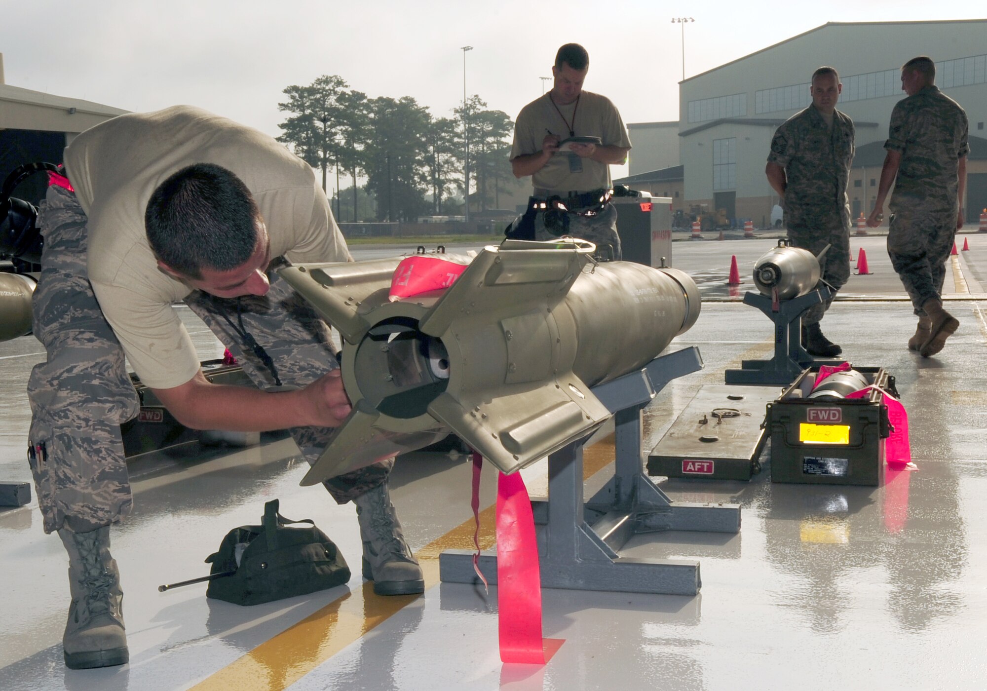 Airman 1st Class Masaud Wahedi, 333rd Aircraft Maintenance Unit weapons load crew chief, is judged as he participates in a quarterly load crew competition on Seymour Johnson Air Force Base, N.C., July 17, 2009. Judges watch all of the competitors closely and take notes on their individual performances. (U.S. Air Force Photo by Airman 1st Class Rae Perry)