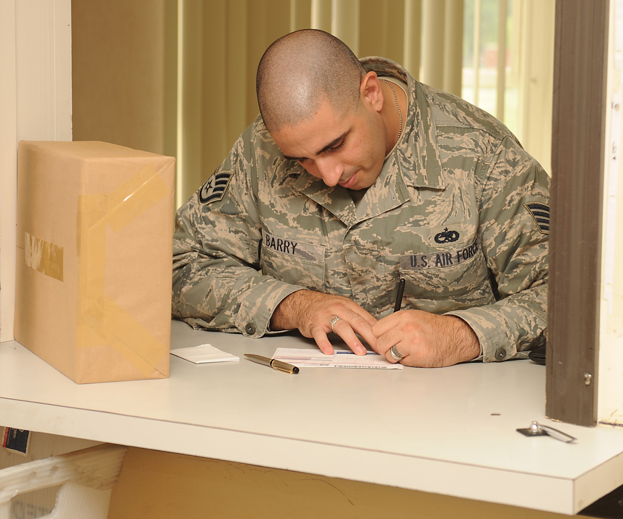 Staff Sgt. Thomas Barry, 4th Equipment Maintenance Squadron unit deployment manager, fills out an express mail label on Seymour Johnson Air Force Base, N.C., July 24, 2009. Created in the 1980s, express mail is a money-back overnight guarantee service offering tracking, proof of delivery, and insurance up to $100. Items shipped using this service can be delivered within 1 to 2 business days. (U.S. Air Force photo by Airman 1st Class Whitney S. Lambert)