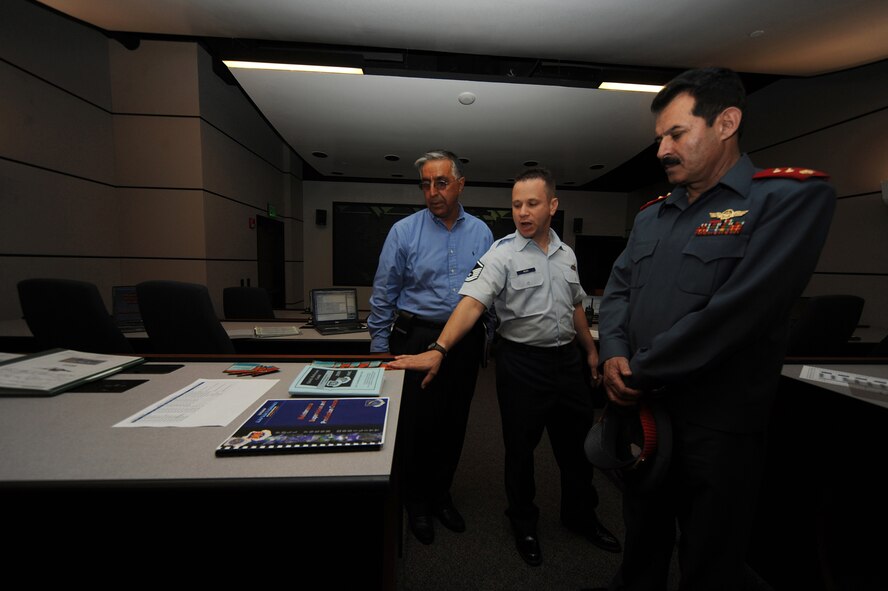 Master Sgt. Richard Woods, director of the Senior Leaders Maintenance Course, explains the maintenance simulator and shows guides and pamphlets to Afghan Maj. Gen. Mohammad Dawran July 13 at the U.S. Air Force Expeditionary Center on Joint Base McGuire-Dix-Lakehurst.  General Dawran, commander of the Afghanistan National Army Air Corps, visited the installation to learn more about the Air Education and Training Command's Air Advisor Course housed at the Expeditionary Center on Fort Dix. (U.S. Air Force Photo/Staff Sgt. Nathan G. Bevier) 