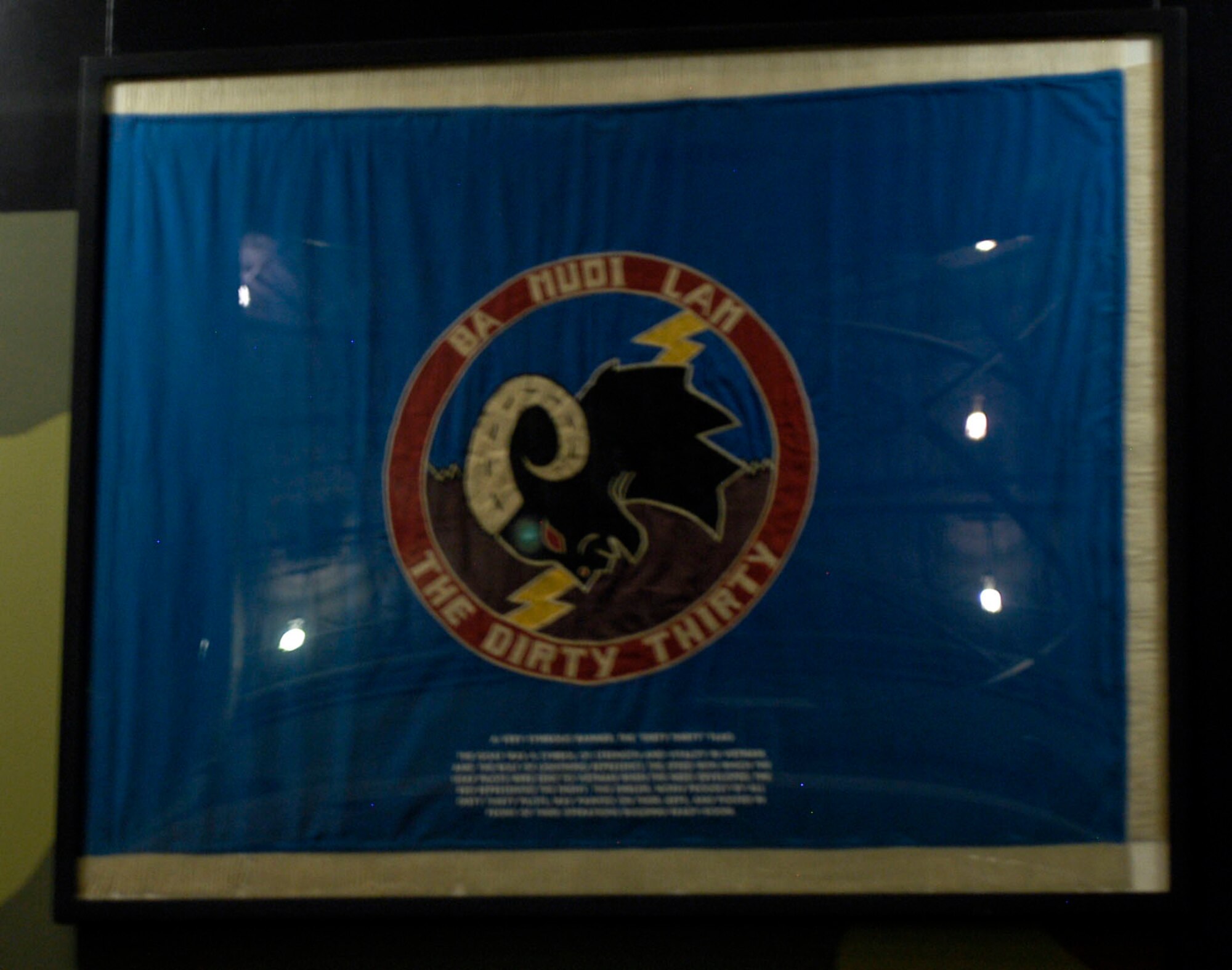 DAYTON, Ohio - The goat was a symbol of strength and vitality in Vietnam and the bolt of lightning represents the speed with which the USAF pilots were sent to Vietnam when the need developed. The red represented the enemy. This emblem, worn proudly by all "Dirty Thirty" pilots, was painted on their jeeps and posted in front of their operations ready-room. This flag is on display in the Southeast Asia War Gallery at the National Museum of the U.S. Air Force. (U.S. Air Force photo)