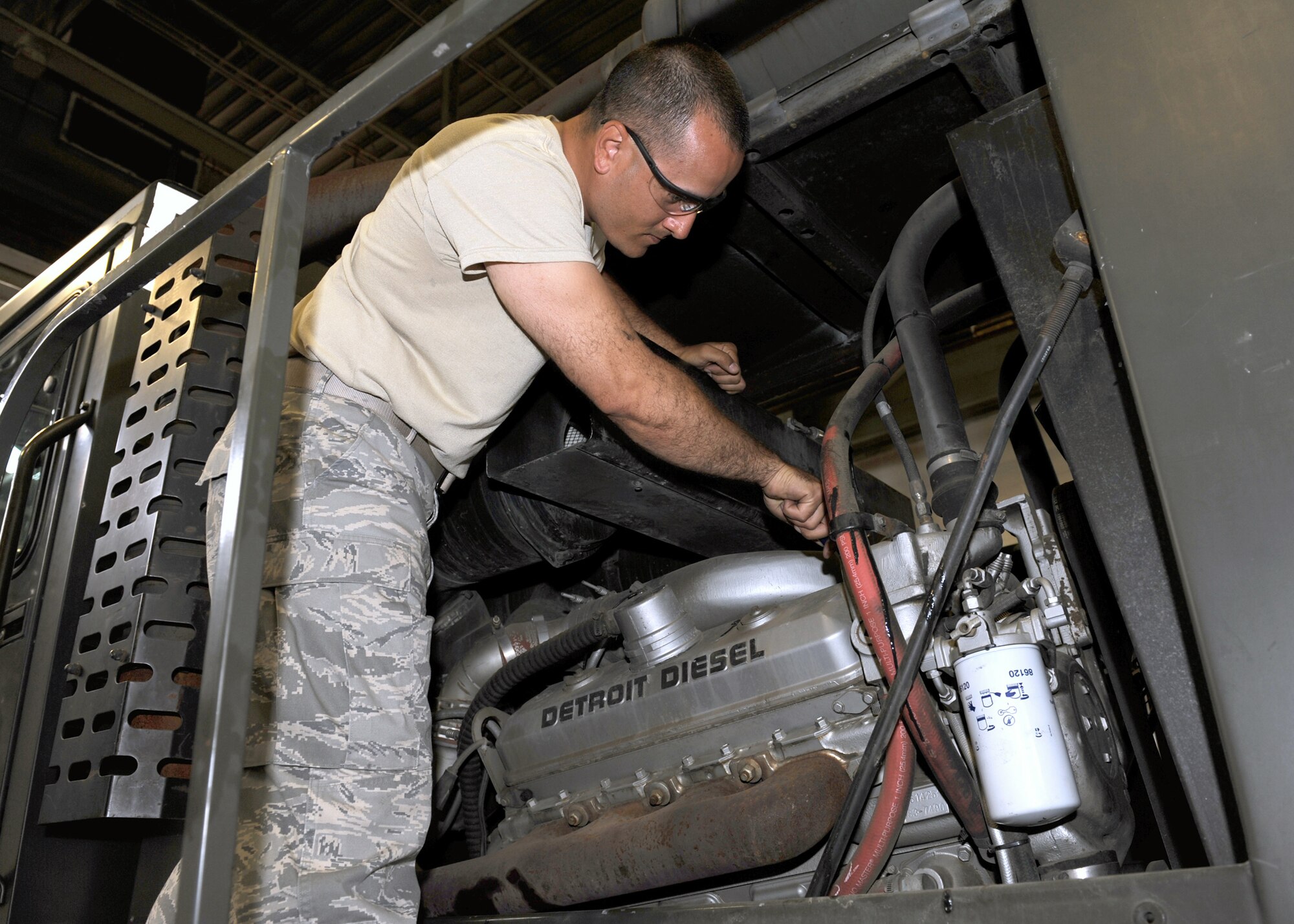 MINOT AIR FORCE BASE, N.D. -- Staff Sgt. Dennis Delgado-Demenech, non-commissioned officer in charge of summer rebuild (5th Logistics Readiness Squadron), repairs an engine on one of the base’s snow plows, here Jul 29. The plows are vital to the base continuing their mission during the coldest days of the winter, by clearing the streets of snow. (U.S. Air Force photo by Staff Sgt. Keith Ballard)