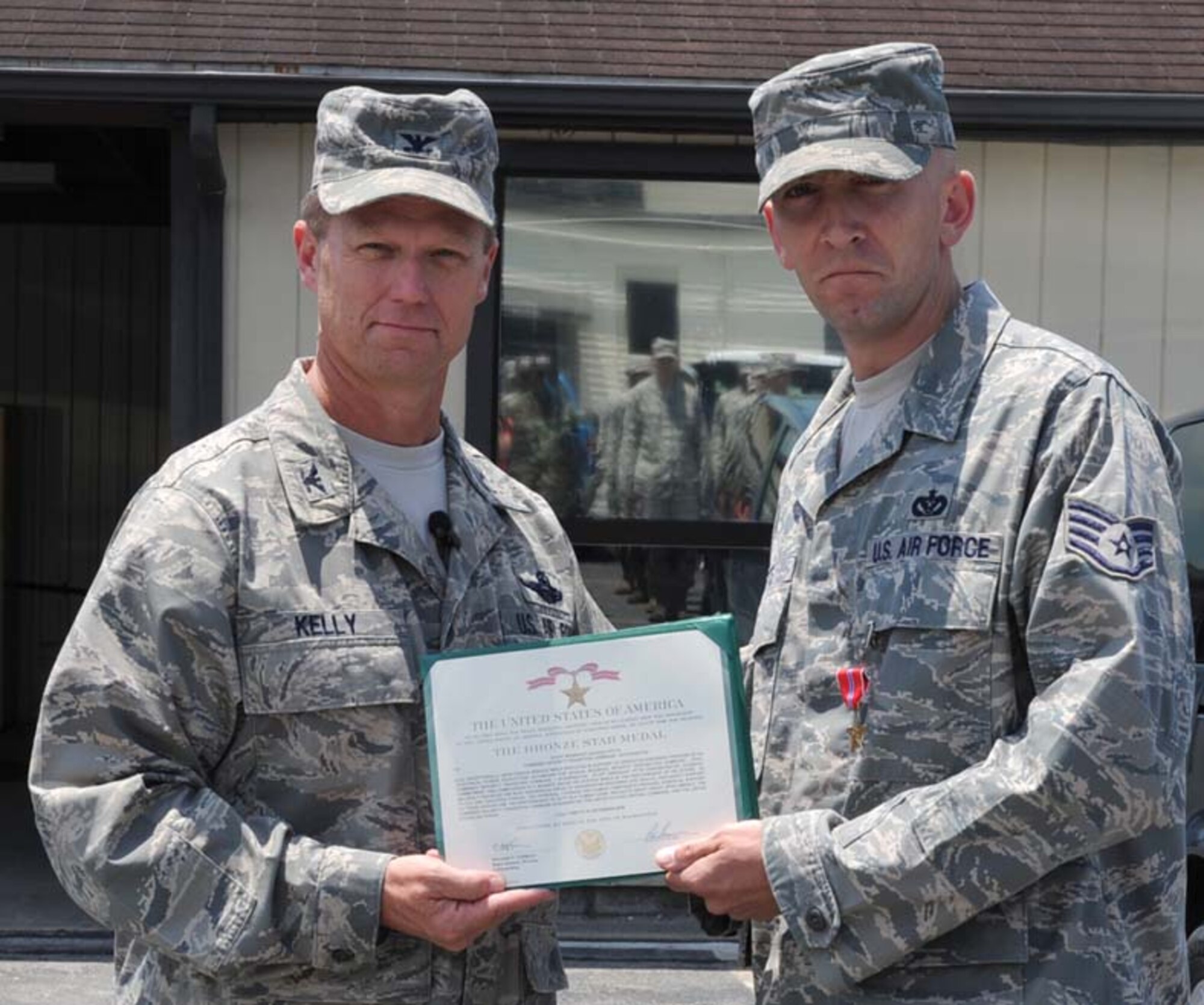 Staff Sgt Zackary Pitts, 4th Civil Engineer Squadron power productions section, is awarded the Bronze Star by Col. Mark D. Kelly, 4th Fighter Wing commander, on Seymour Johnson Air Force Base, N.C., July 20, 2009. While on an in-lieu-of assignment attached to the 755th Air Expeditionary Group in Afghanistan, Sergeant Pitts provided electrical, structural, heating, ventilation and cooling support for several forward operating bases across the country.  He participated in various humanitarian missions, handing out food and assisting with medical care to citizens of Afghanistan. During this deployment, he went on several convoys and witnessed first-hand the importance of pulling together to accomplish a mission. He hopes to help other Airmen prepare for deployments by encouraging them to be the best at their job, be confident, and expect to work long, but very fulfilling, hours. (U.S. Air Force photo by Airman 1st Class Gino Reyes)