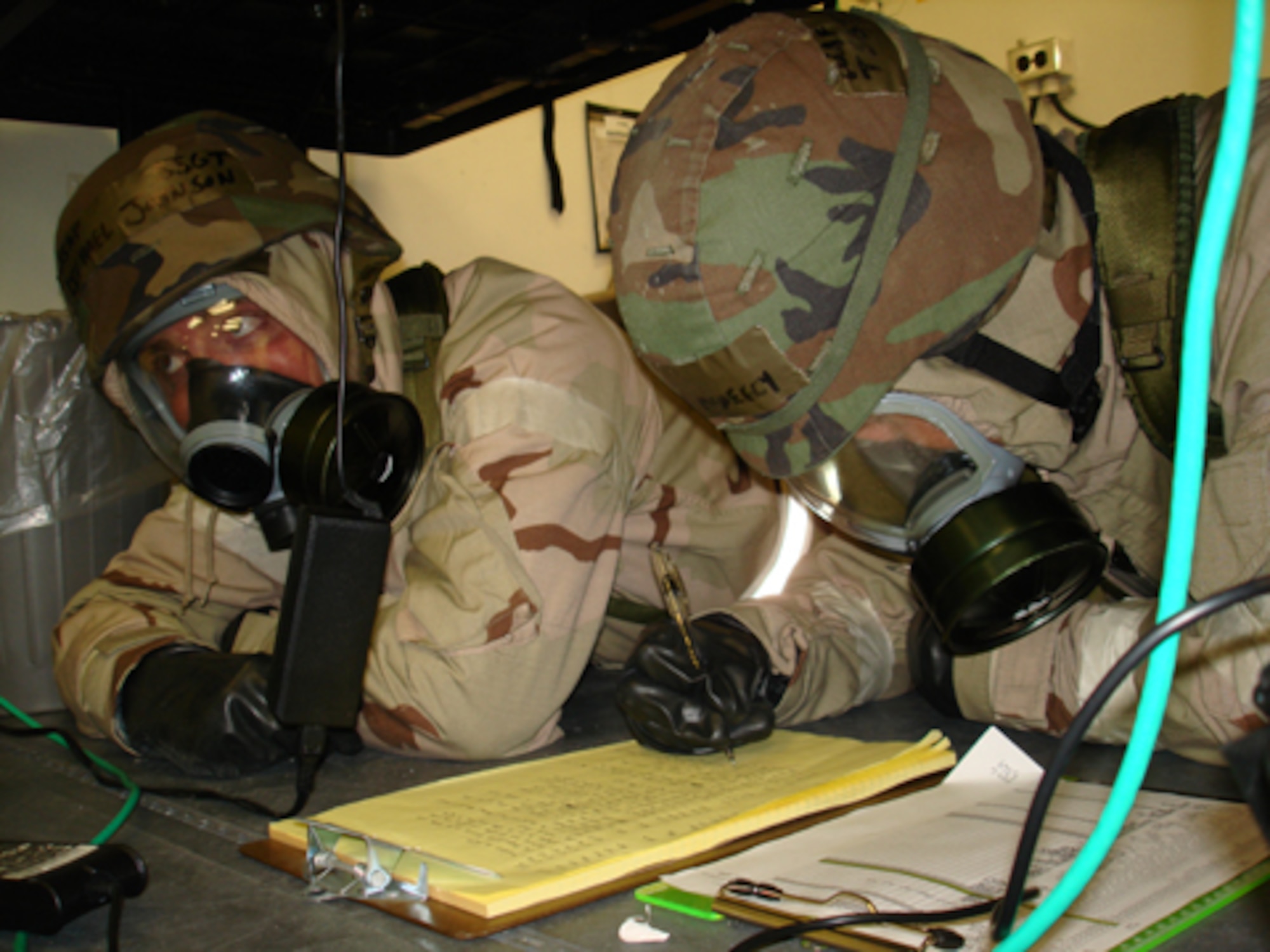 Tech. Sgt Nathan McNeely and Staff Sgt Michael Johnson, 21st Air Mobility Squadron, take cover and accountability during the simulated ground attack July 23.
During the exercise, the Air Mobility Commander inspector general team evaluated the members of the 21st AMOS’ capability on a variety of skill sets, including their ability to survive and operate during attacks, and self aid and buddy care. (U.S. Air Force photo/Staff Sgt. Frank Lalic