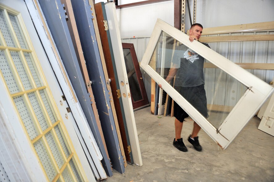 SHAW AIR FORCE BASE, S.C. -- Senior Airman Jason Albrecht, 20th Security Forces military working dog handler, organizes donated doors at the Sumter Habitat for Humanity ReStore, July 27. Proceeds from ReStore sales go into the Sumter Habitat for Humanity building fund. Habitat for Humanity is a non-profit organization that utilizes volunteer labor and donations of money and materials to eliminate poverty housing and homelessness. (U.S. Air Force photo/Senior Airman Kathrine McDowell)

