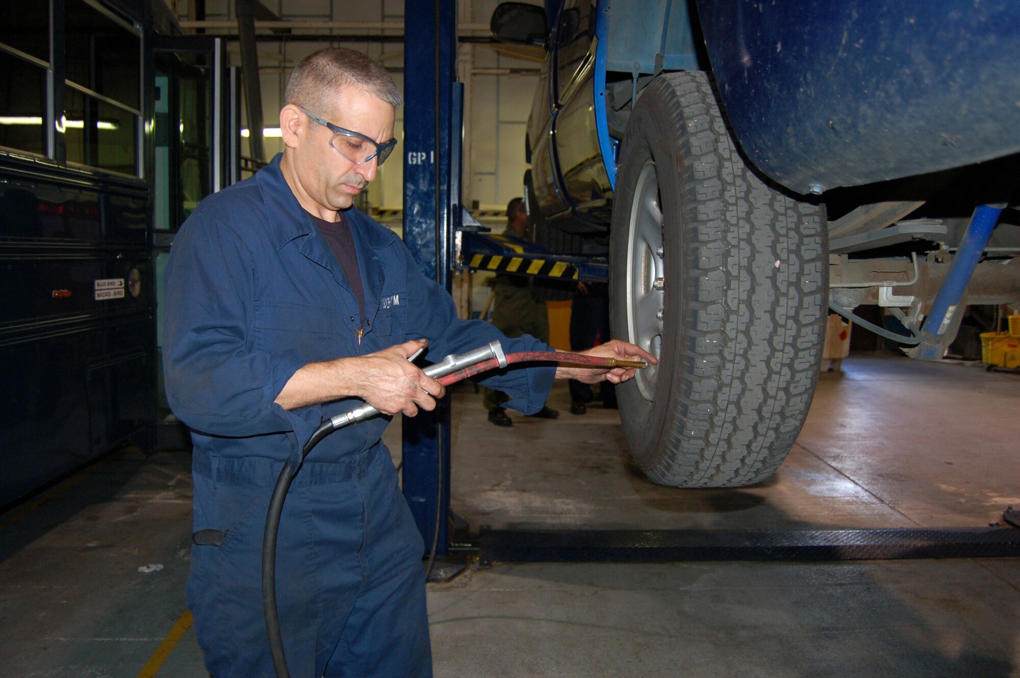 WRIGHT-PATTERSON AIR FORCE BASE, Ohio - Tech. Sgt. Angel Gonzalez, 445th Logistics Readiness Squadron vehicle maintenance, checks the air pressure on a vehicle at Royal Air Force Mildenhall, United Kingdom.  Approximately 60 individuals from the 445 LRS performed their annual training at Mildenhall July 11-25. (U. S. Air Force photo/Maj. Jose A. Cardenas)