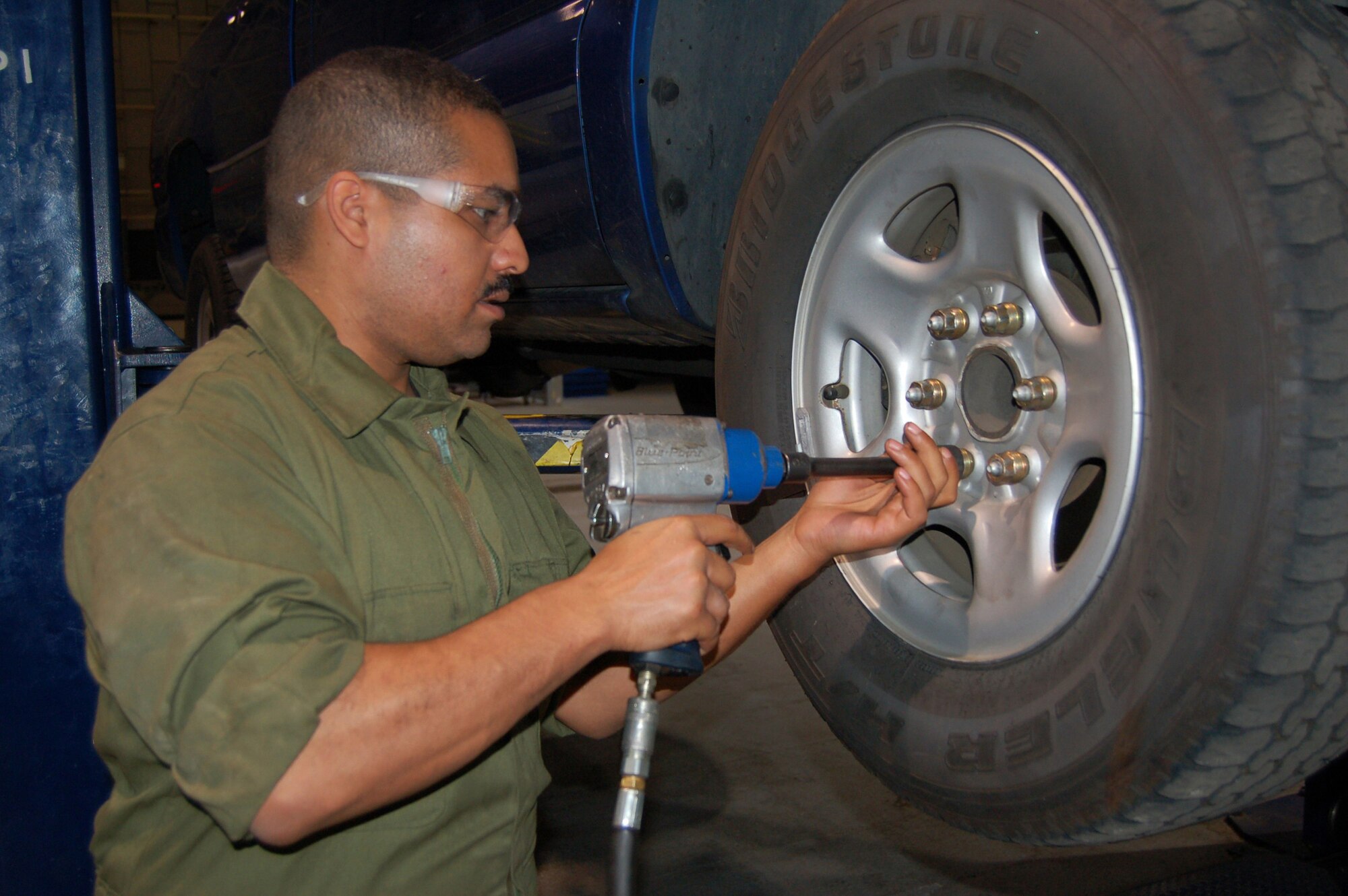 WRIGHT-PATTERSON AIR FORCE BASE, Ohio - Staff Sgt. Laurence Saldana, 445th Logistics Readiness Squadron, tightens lugs nuts on a vehicle at Royal Air Force Mildenhall, United Kingdom.  Approximately 60 individuals from the 445 LRS performed their annual training at Mildenhall July 11-25. (U. S. Air Force photo/Maj. Jose A. Cardenas)