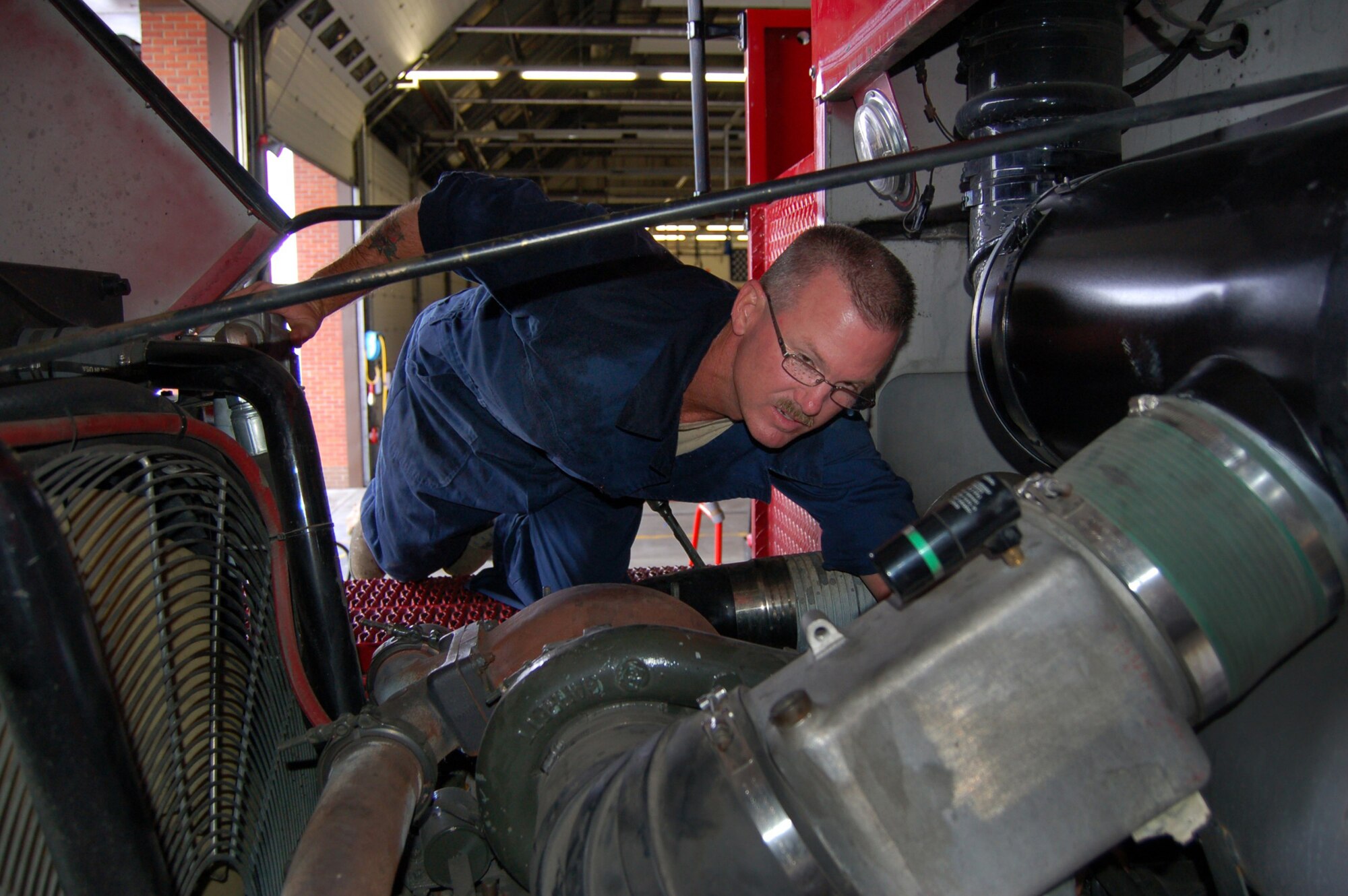 WRIGHT-PATTERSON AIR FORCE BASE, Ohio - Tech. Sgt. David Mashburn, 445th Logistics Readiness Squadron vehicle maintenance, performs scheduled maintenance on a fire truck at Royal Air Force Mildenhall, United Kingdom.  Approximately 60 individuals from the 445 LRS performed their annual training at Mildenhall July 11-25. (U. S. Air Force photo/Maj. Jose A. Cardenas)