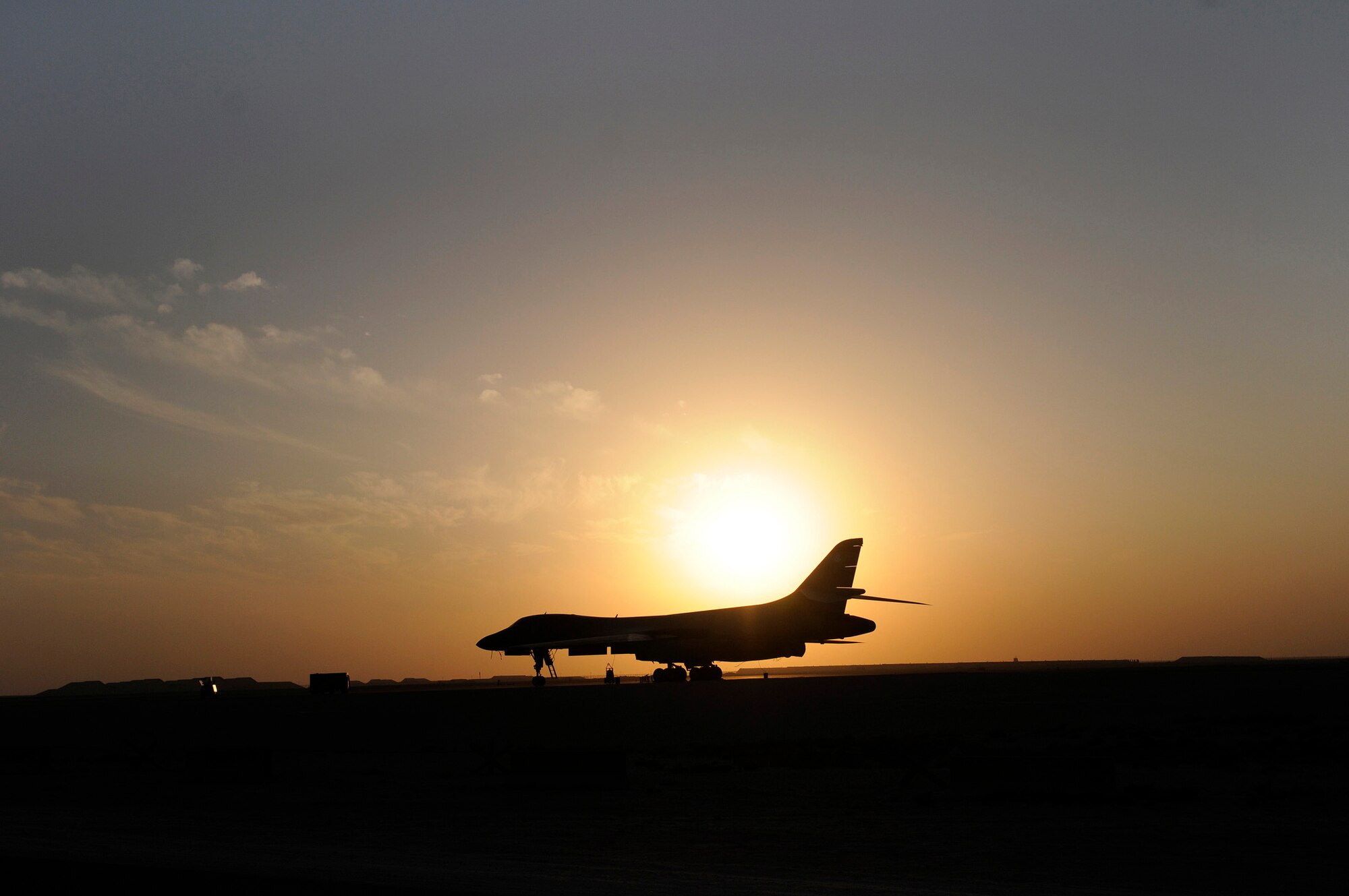 The setting sun silhouettes a B-1B Lancer in Southwest Asia. The B-1B has the capability to carry guided and unguided weapons and deliver massive quantities of precision and non-precision weapons against specific targets. (U.S. Air Force photo/Tech. Sgt. Michael Boquette)